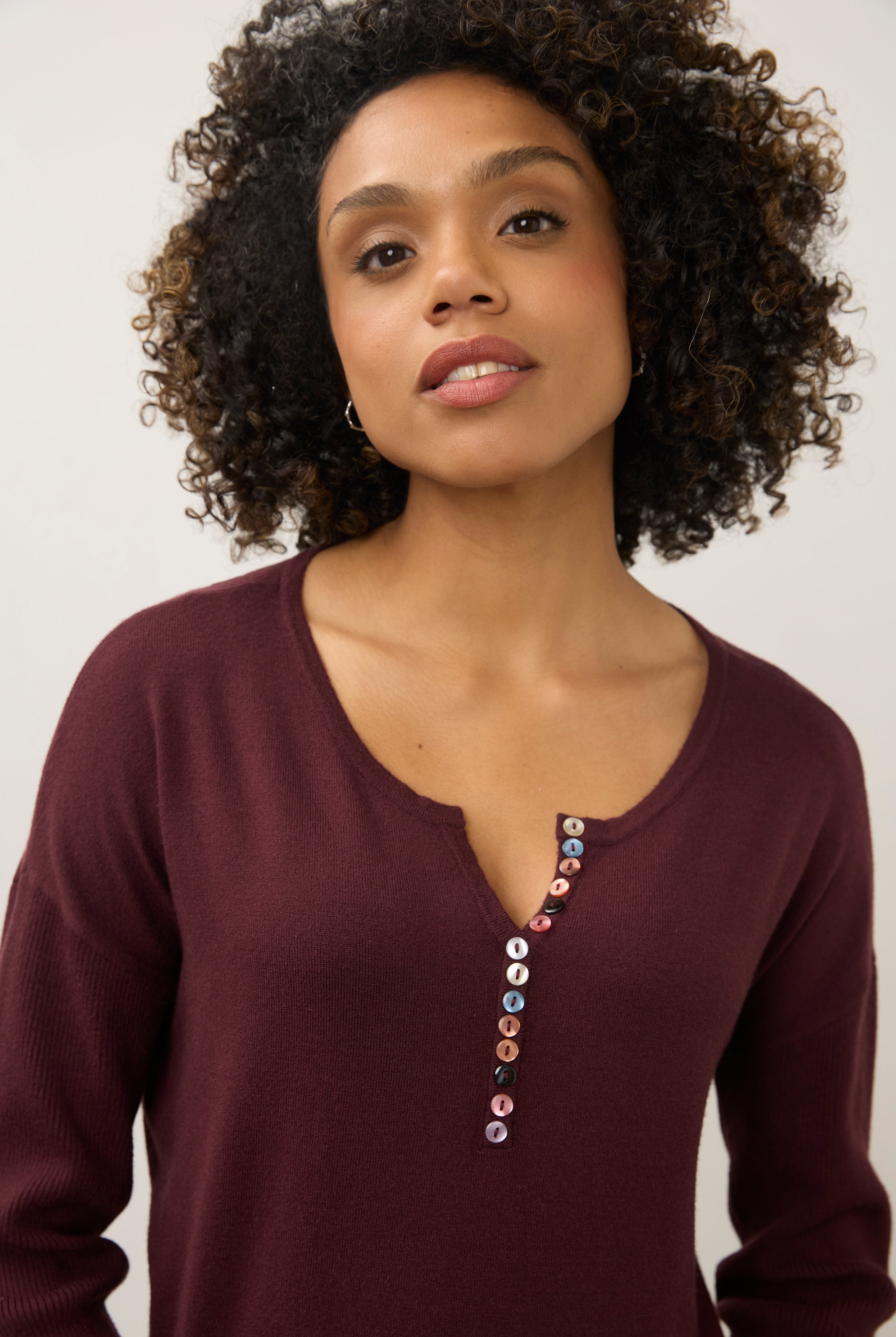Close-up of burgundy sweater focusing on button accents by French Dressing Jeans (FDJ)