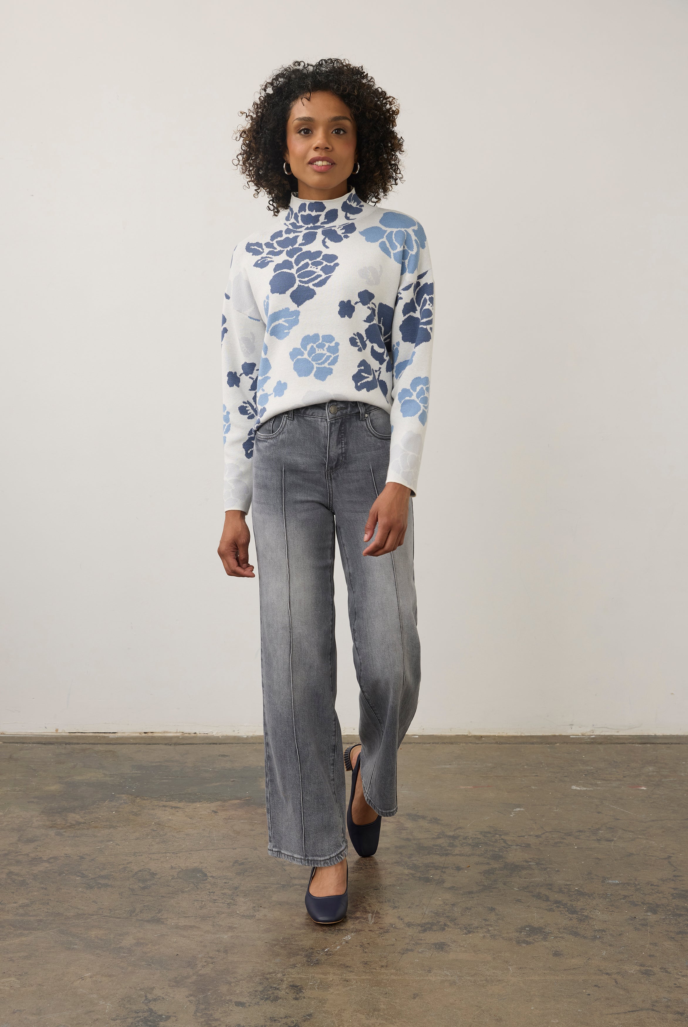 Model in blue floral sweater with grey jeans, full outfit view by French Dressing Jeans (FDJ)