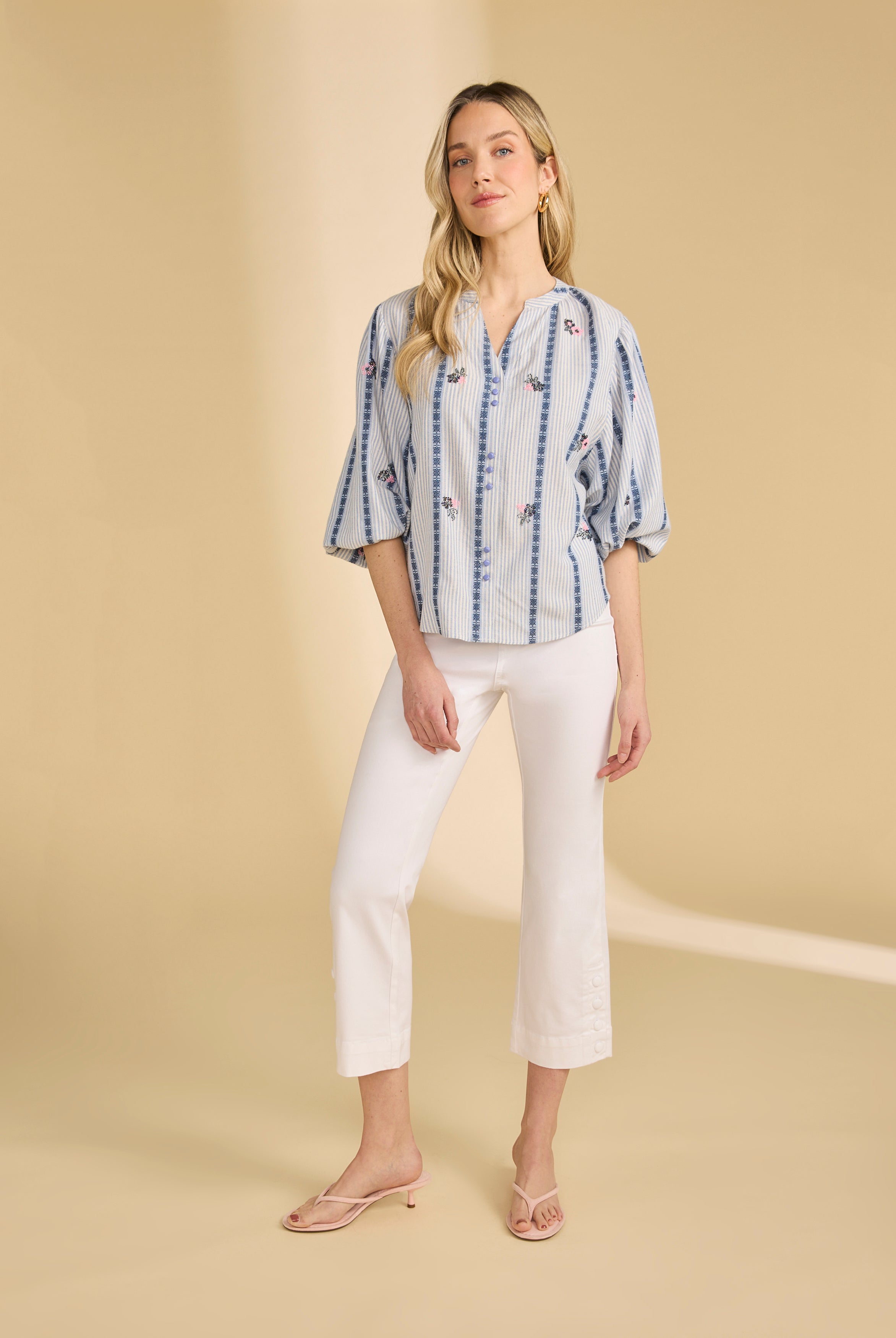 Full view of striped shirt with floral accents paired with white cropped pants by French Dressing Jeans (FDJ)