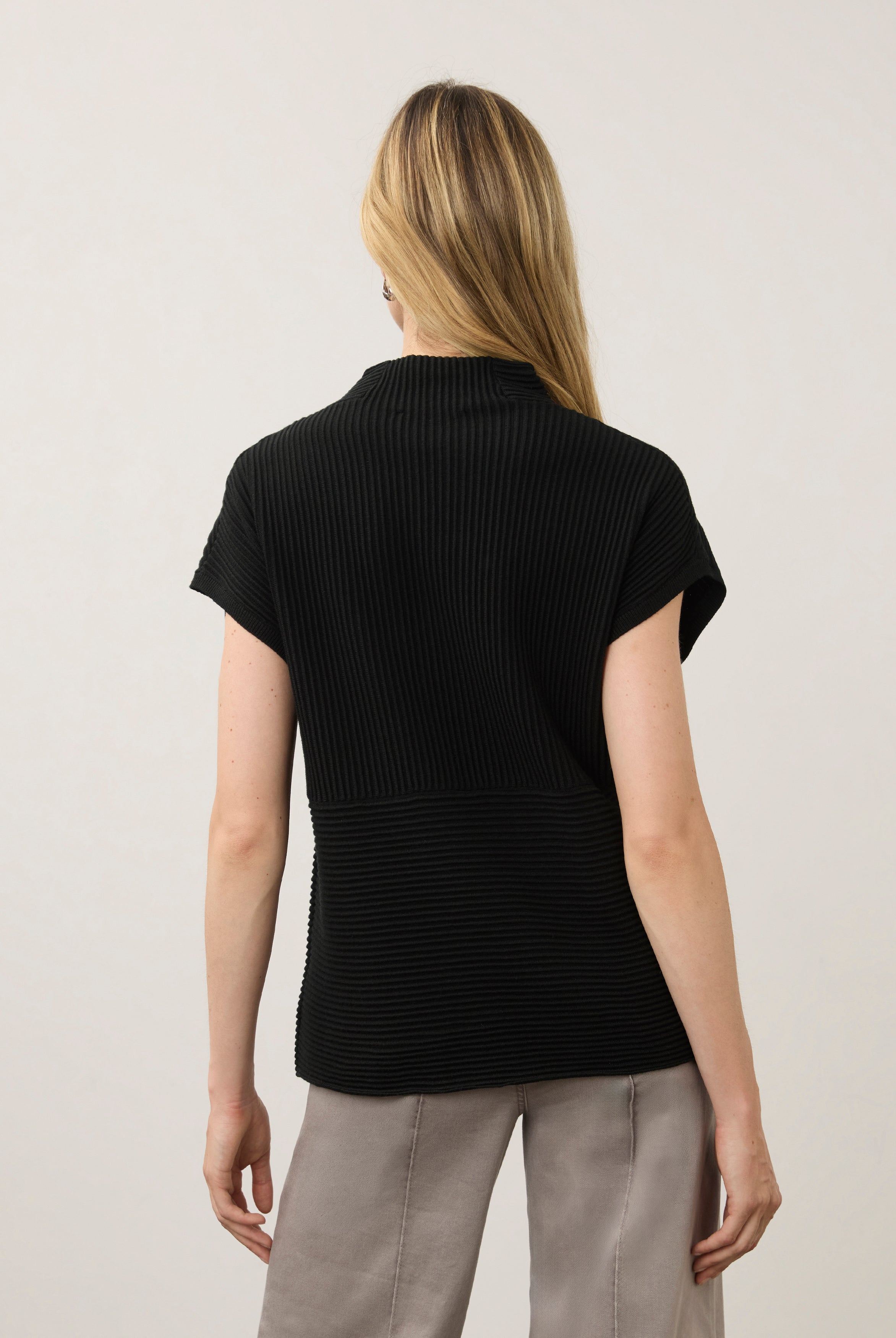 Back view of black ribbed top with high collar showcasing seamless design by French Dressing Jeans (FDJ)