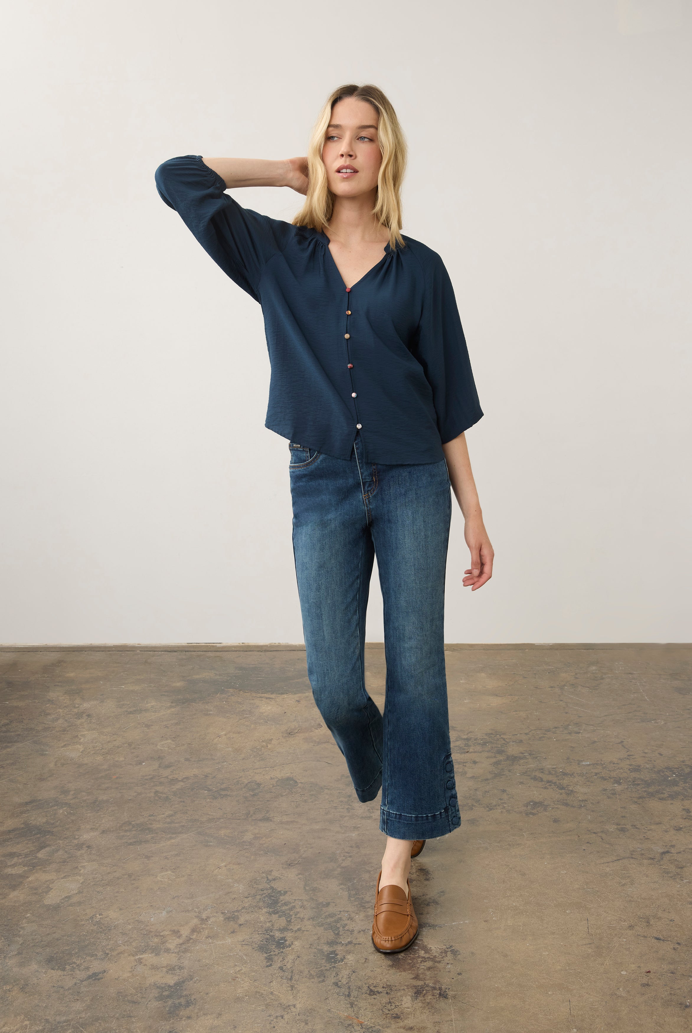Model in navy blouse and jeans, full body view by French Dressing Jeans (FDJ)