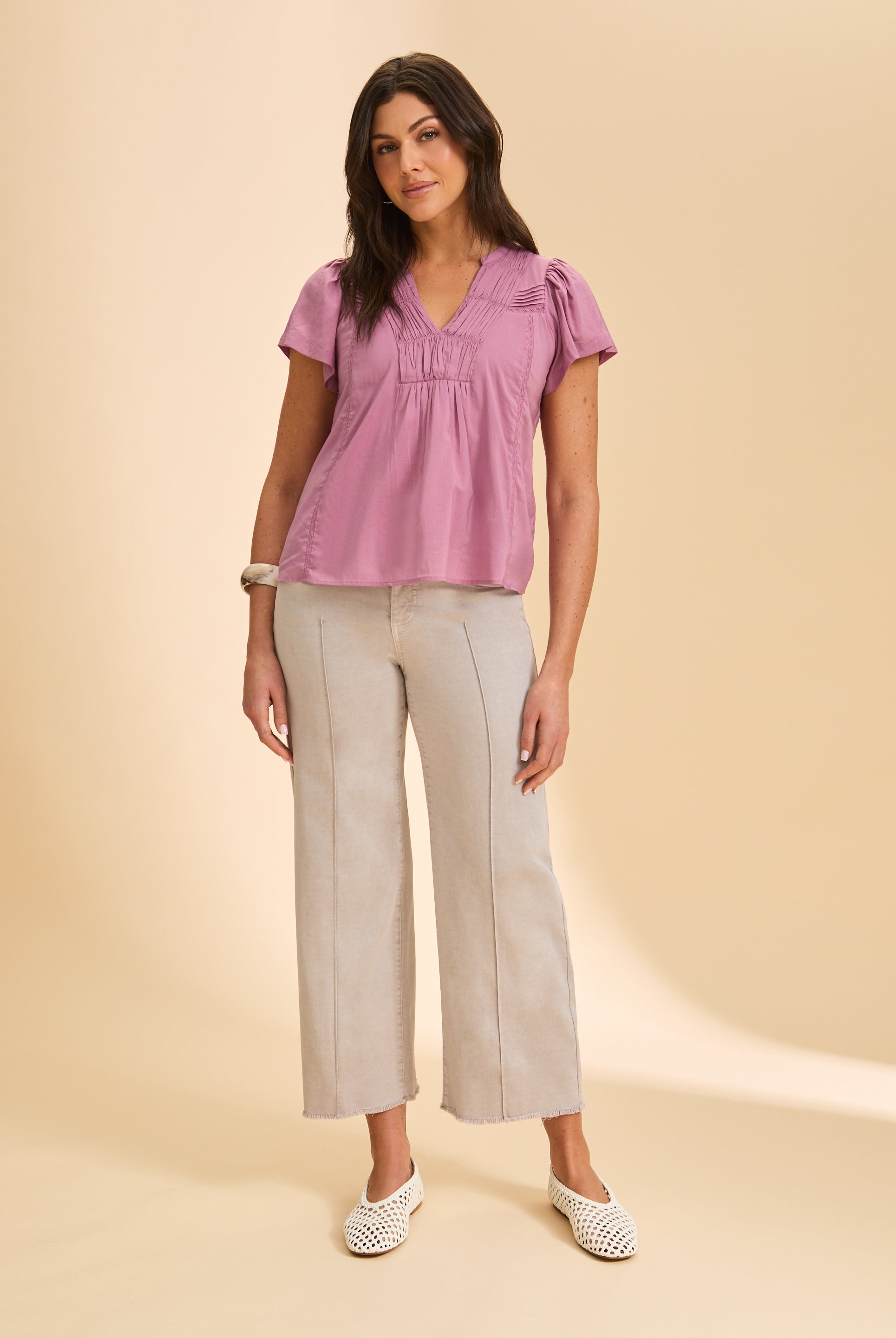 Full view of lavender short-sleeve top paired with beige pants by French Dressing Jeans (FDJ)