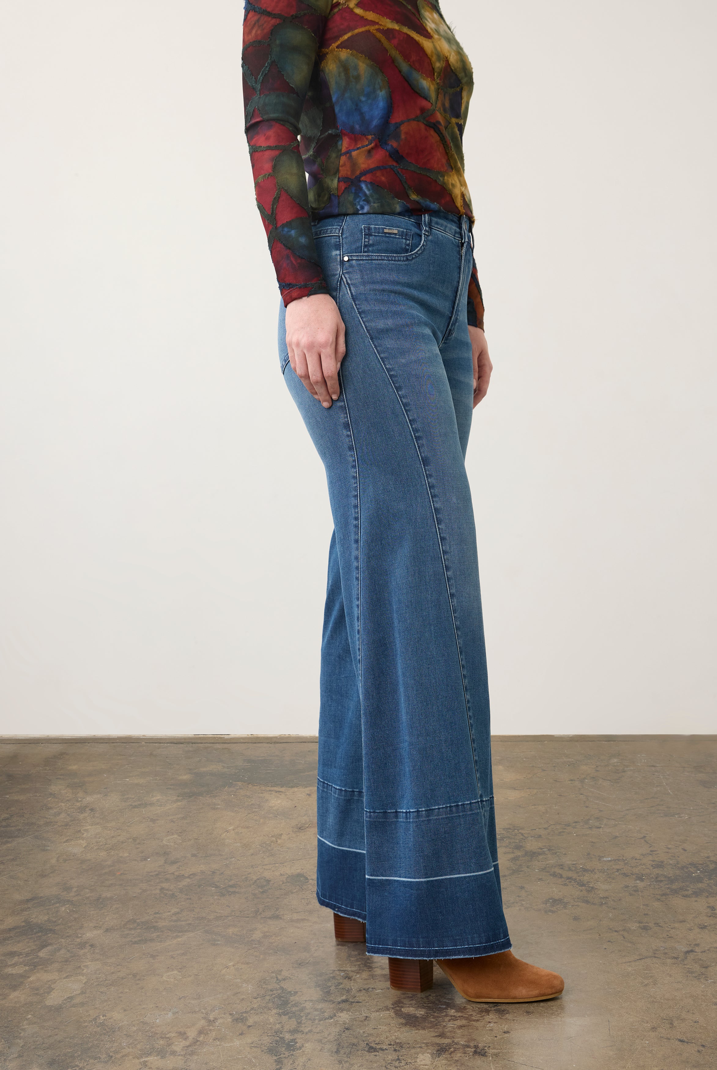 Side view of wide-leg dark wash jeans with artistic top, highlighting leg silhouette by French Dressing Jeans (FDJ) par French Dressing Jeans (FDJ)