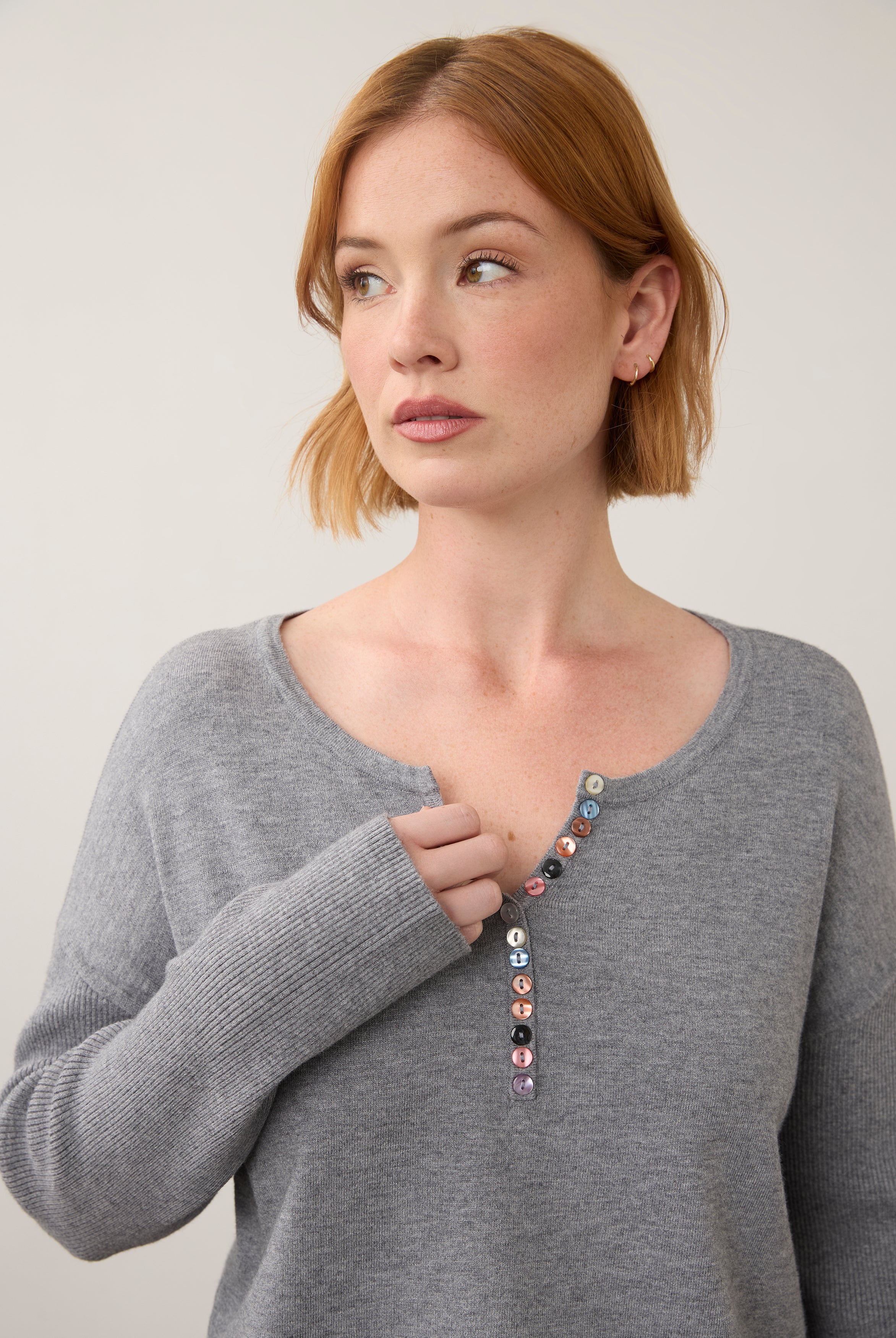 Close-up of grey sweater focusing on button details by French Dressing Jeans (FDJ)