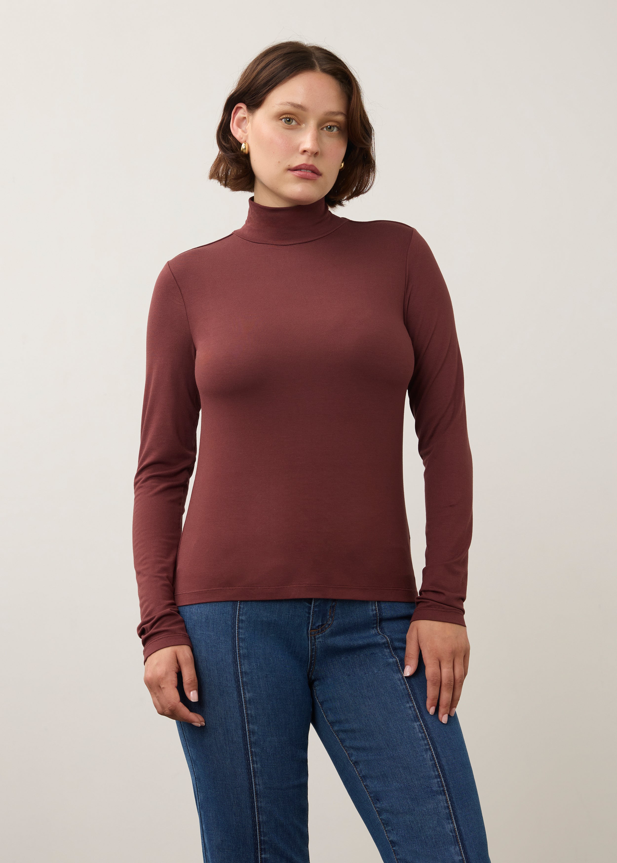 Front view of burgundy long sleeve turtleneck top with rich color and sleek fit by French Dressing Jeans (FDJ)