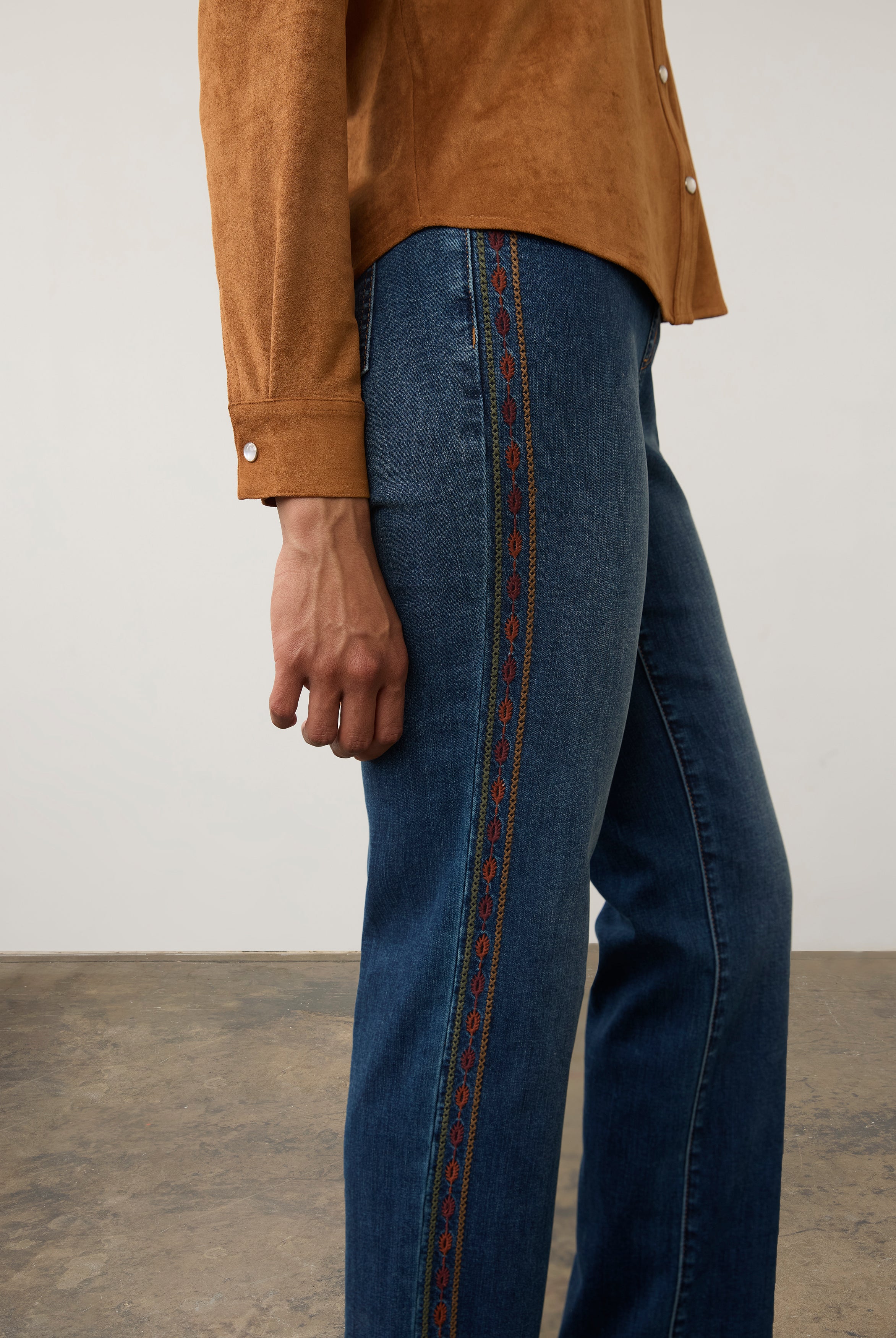 Side detail of medium blue jeans with decorative embroidery along the seam by French Dressing Jeans (FDJ) par French Dressing Jeans (FDJ)