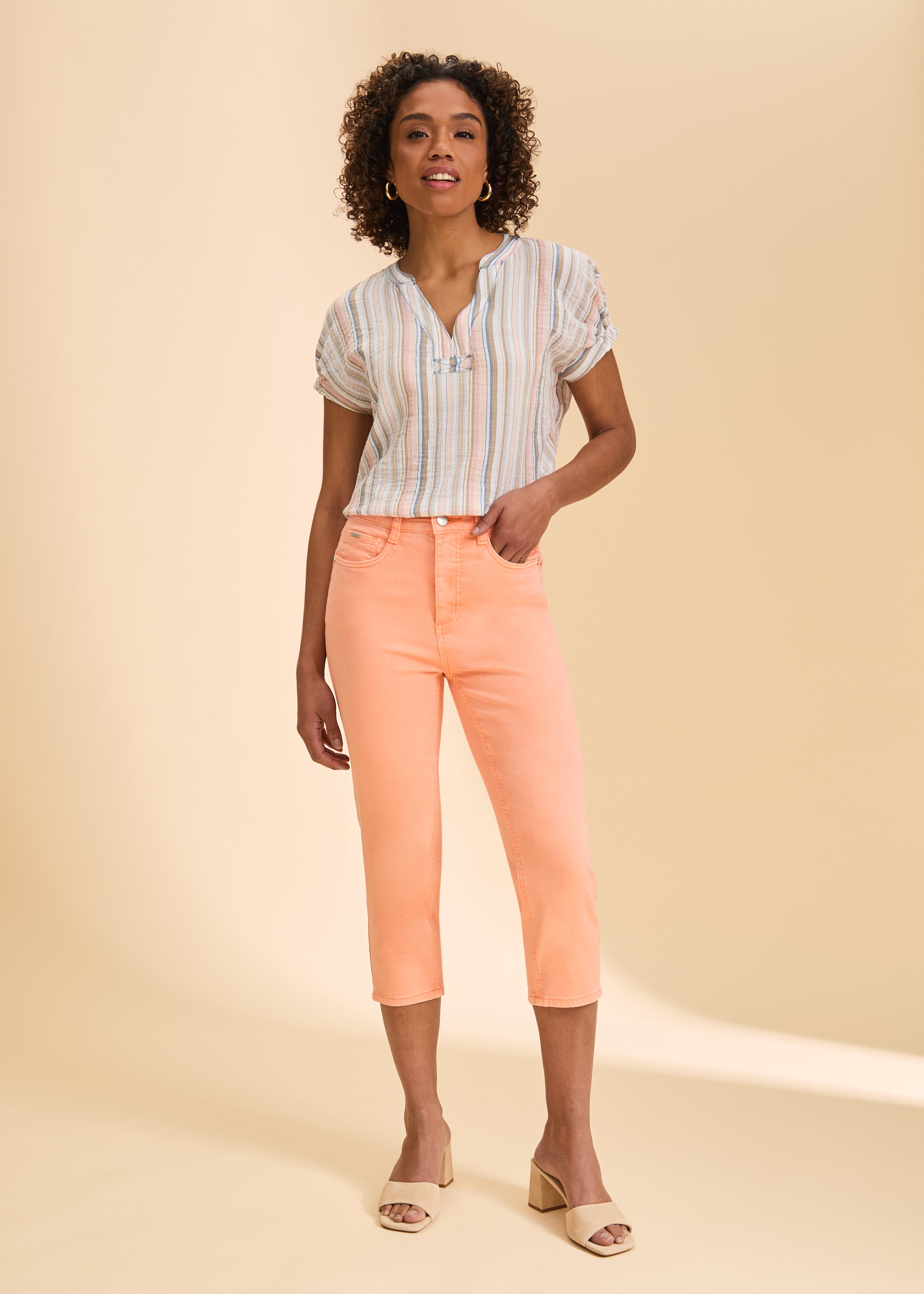 Front view of peach cropped jeans, styled with striped top by French Dressing Jeans (FDJ)