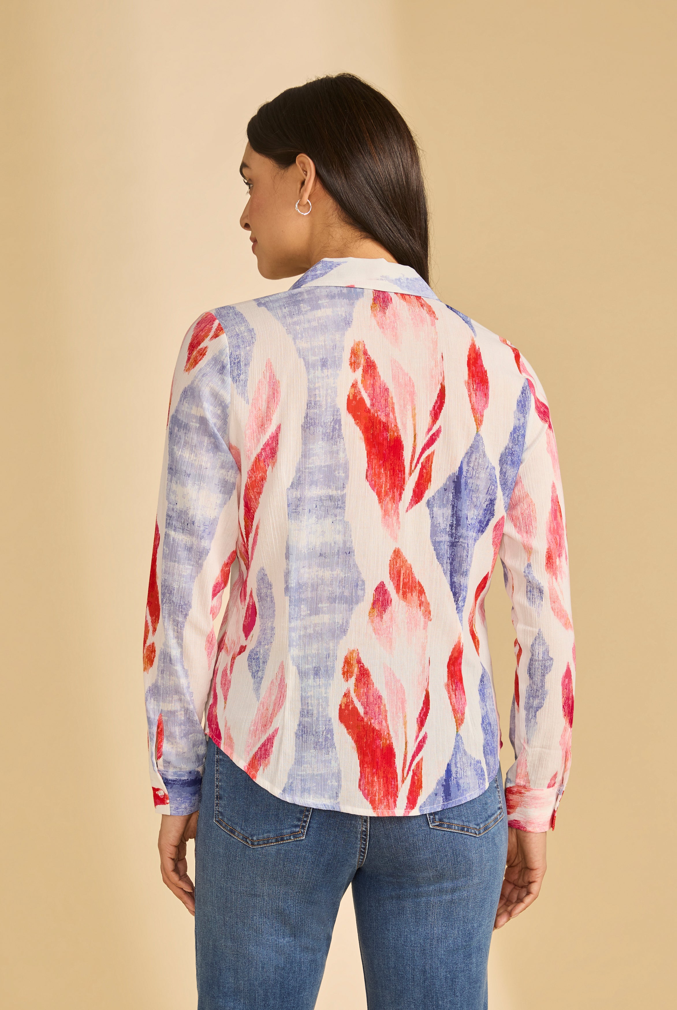 Back view of colorful long sleeve blouse showcasing bold pattern and curved hem, by French Dressing Jeans (FDJ)