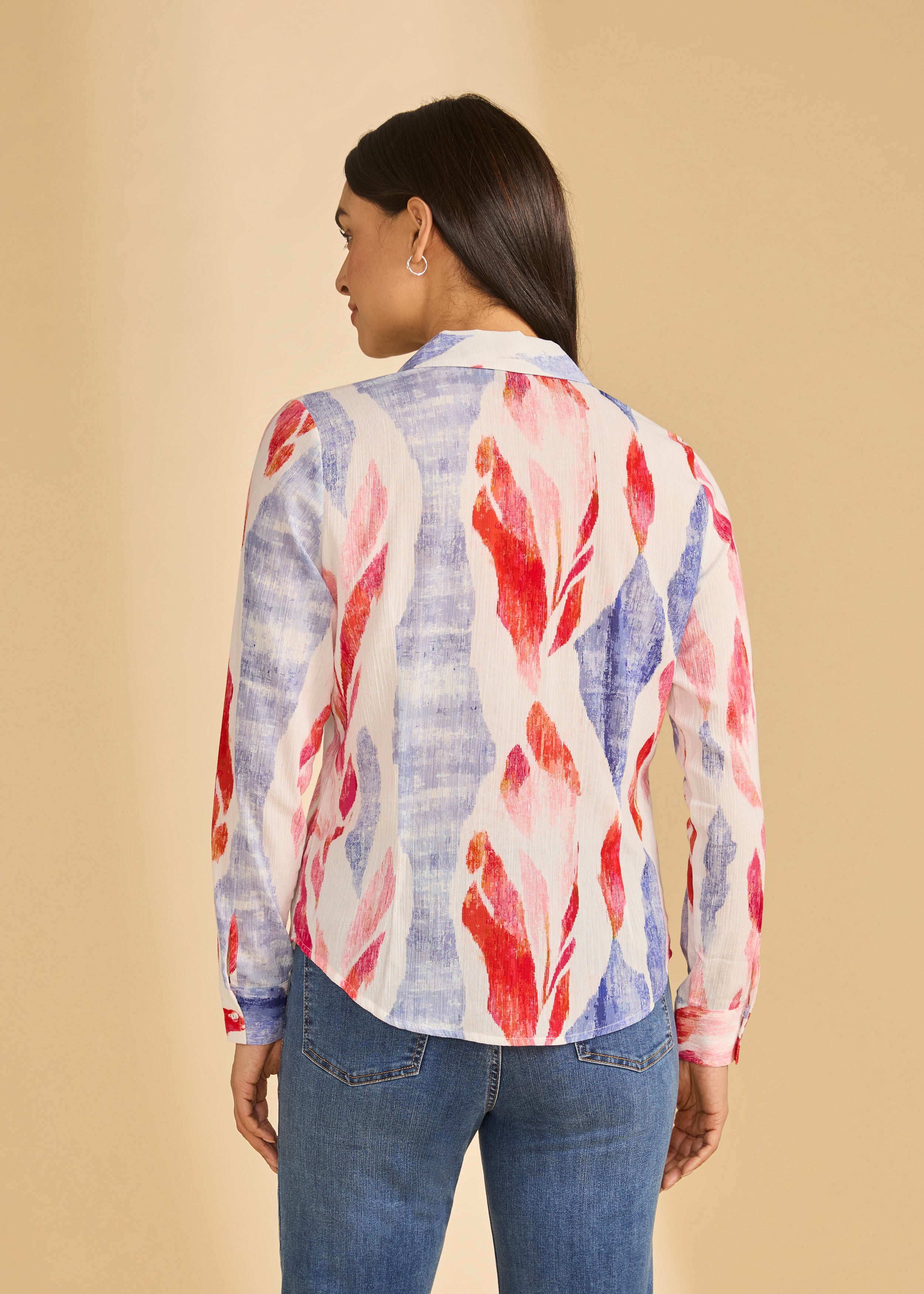 Back view of colorful long sleeve blouse showcasing bold pattern and curved hem, by French Dressing Jeans (FDJ)