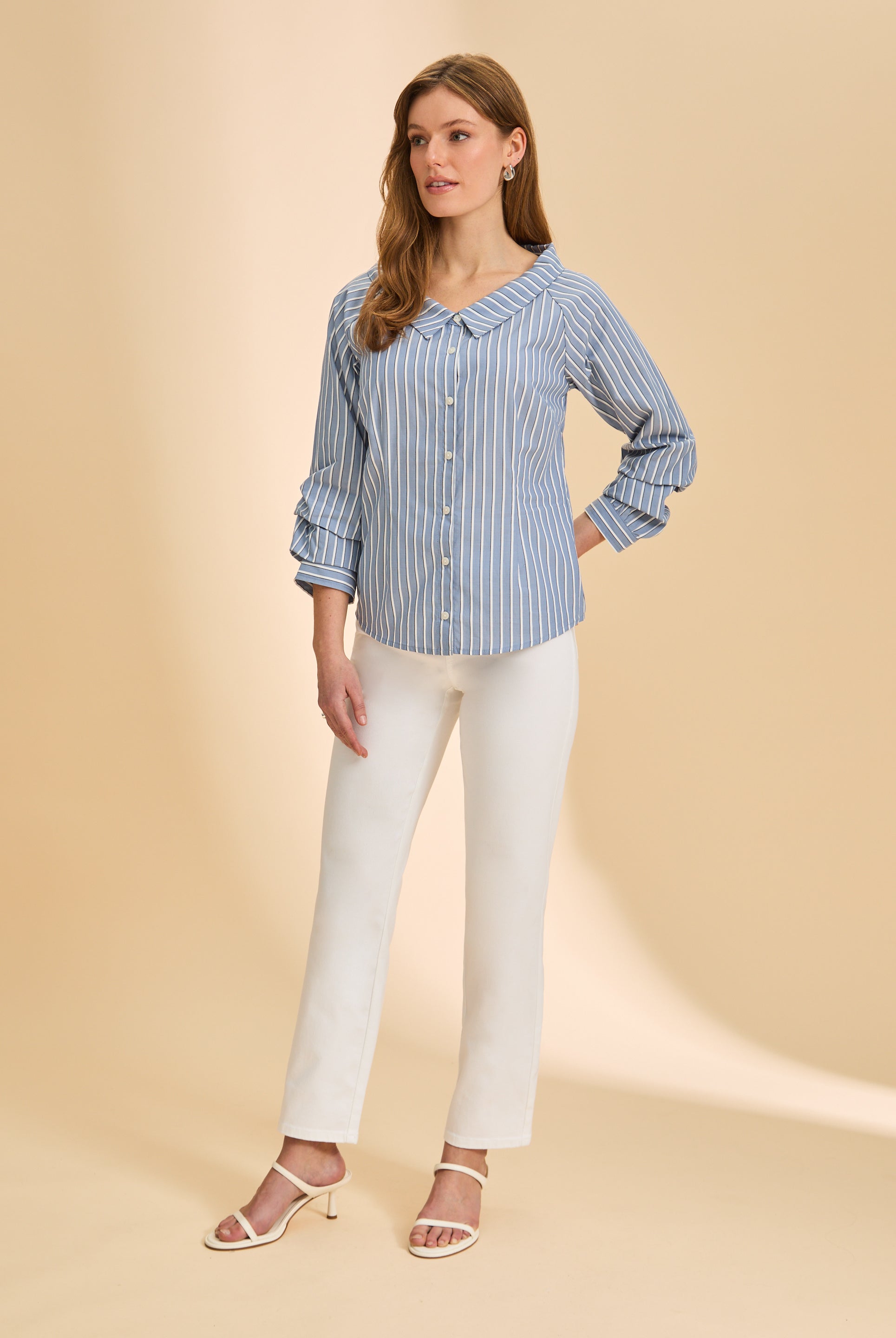 Full view of blue striped shirt paired with white pants and heels by French Dressing Jeans (FDJ)