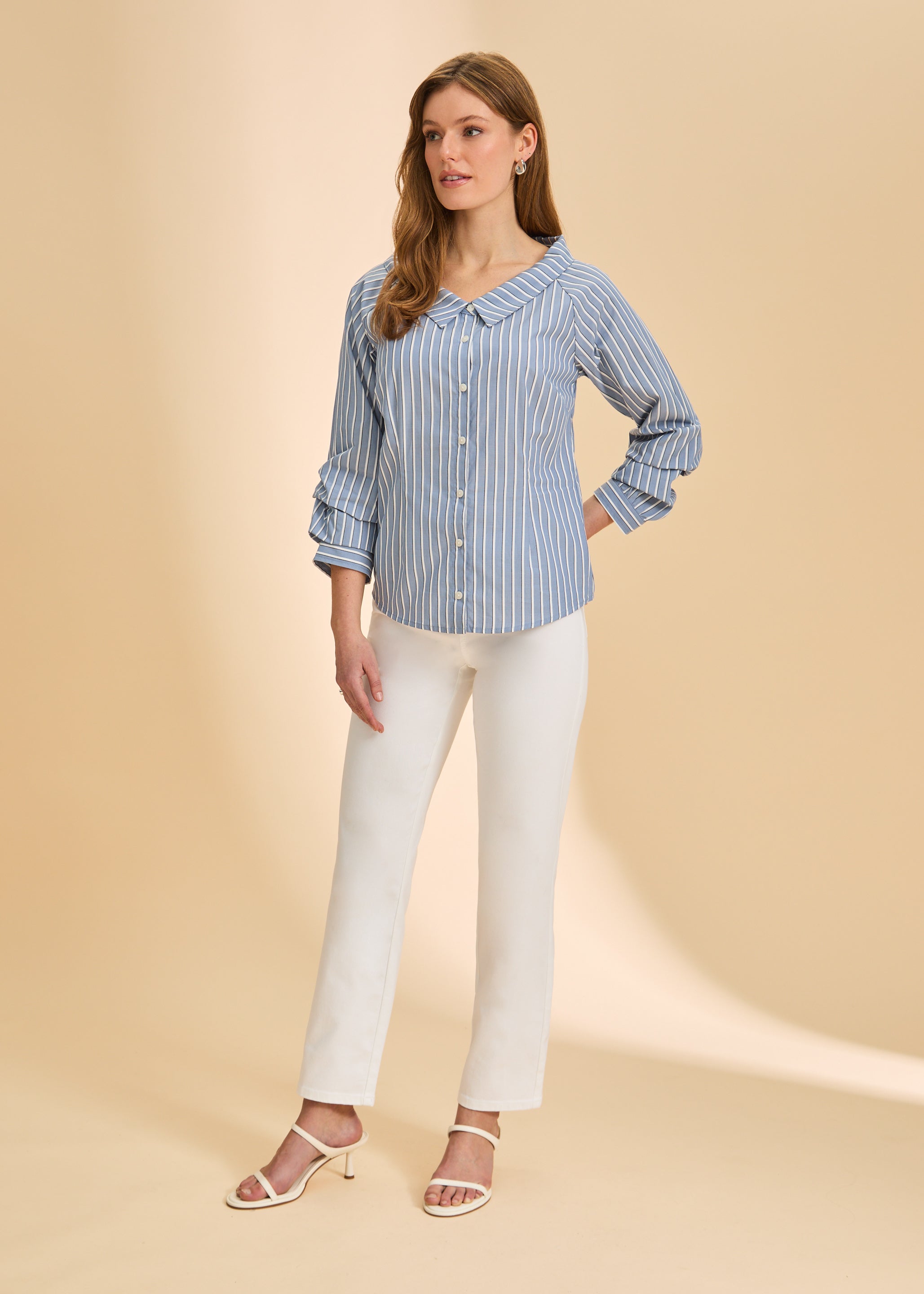 Full view of blue striped shirt paired with white pants and heels by French Dressing Jeans (FDJ)