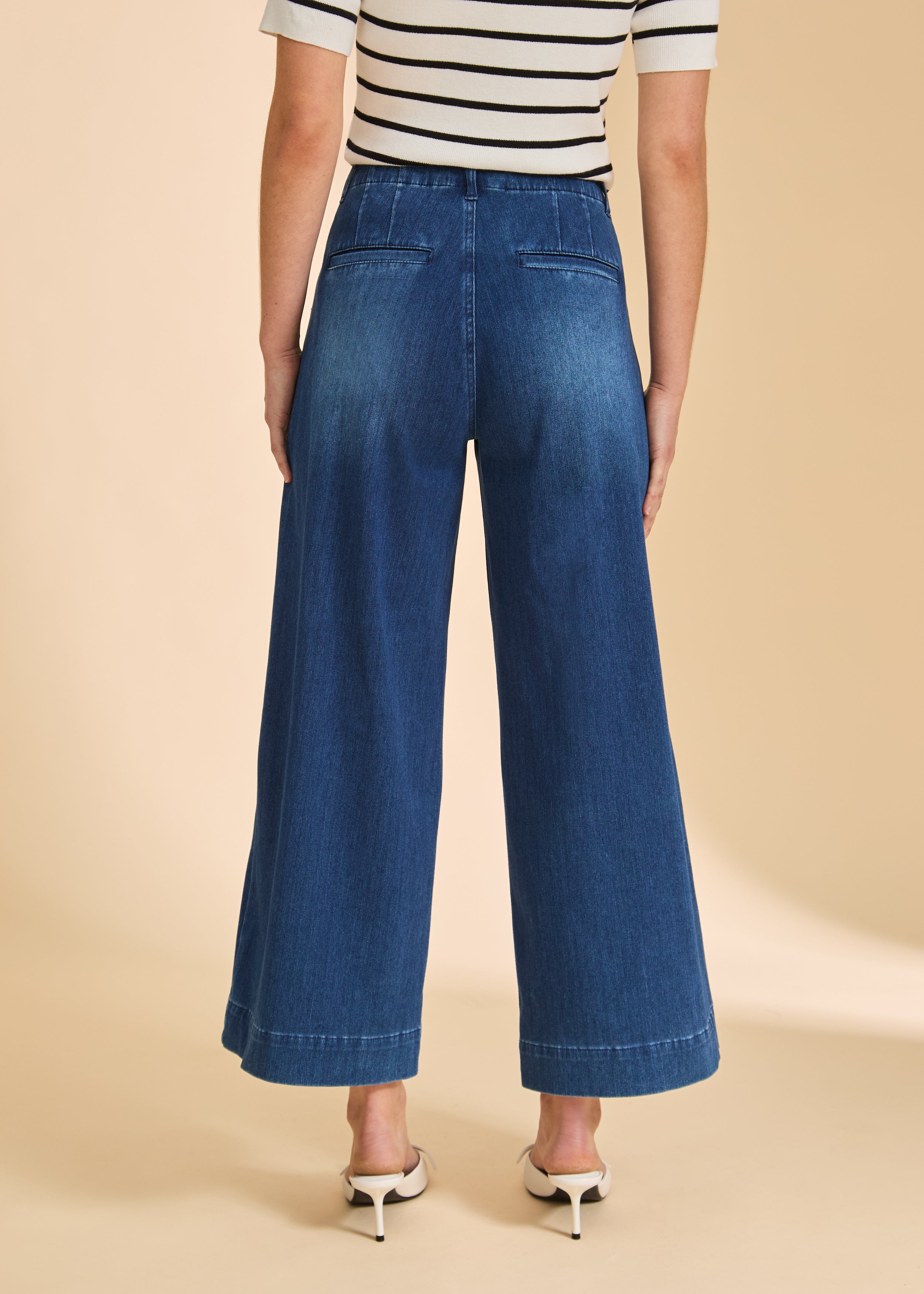 Back view of wide-leg dark blue denim pants highlighting back pockets by French Dressing Jeans (FDJ)
