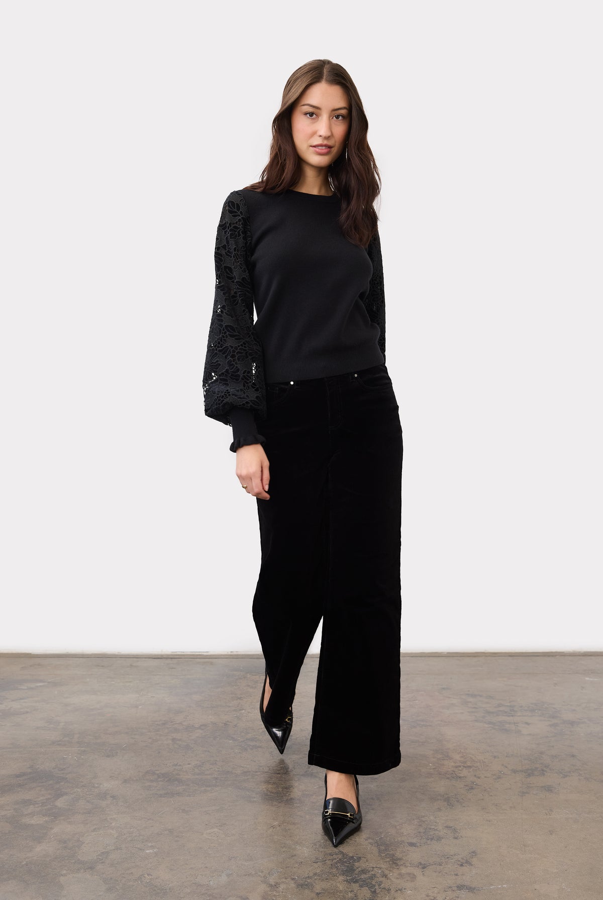 Full view of model wearing black Olivia wide leg pants paired with a black top by French Dressing Jeans (FDJ)