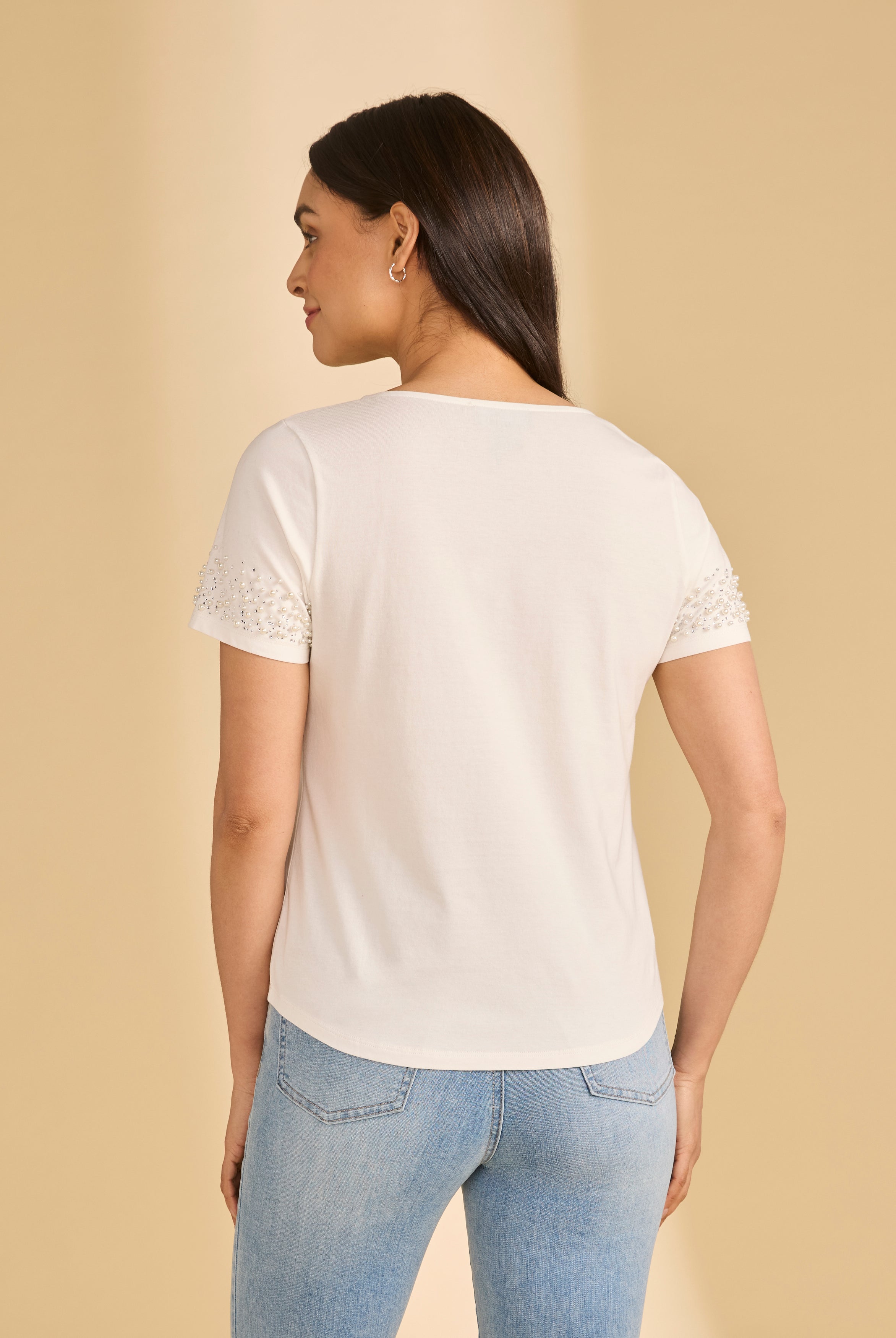 Back view of white V-neck top showcasing pearl-trimmed sleeves by French Dressing Jeans (FDJ)