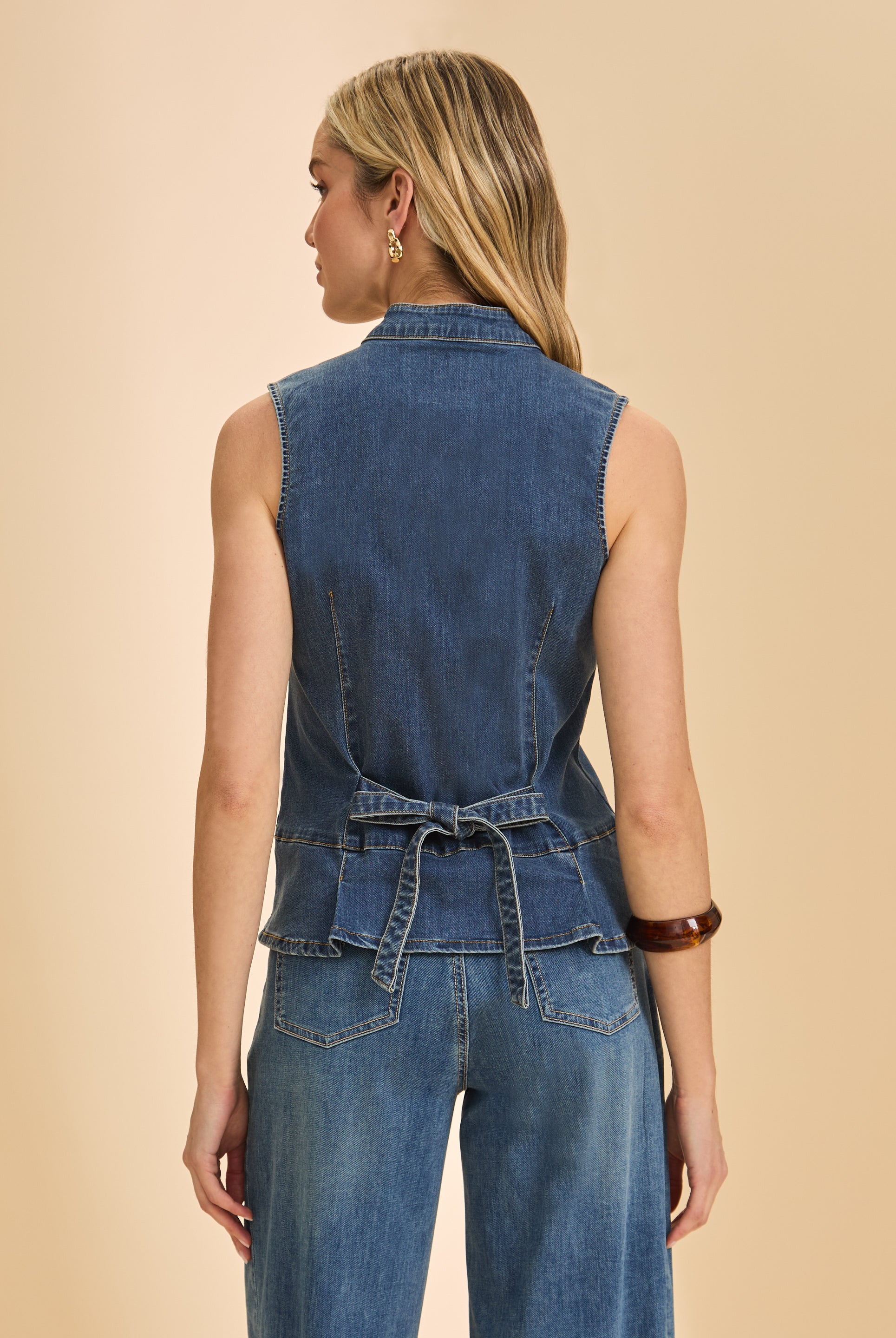 Back view of dark wash sleeveless denim top with tie detail and seam lines by French Dressing Jeans (FDJ)