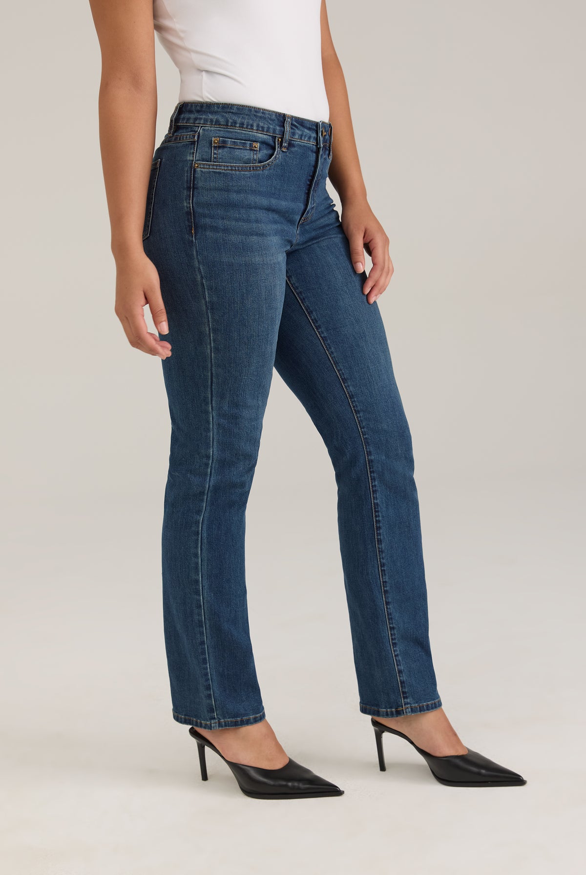 Side profile of Olivia straight leg denim in dark wash highlighting slim fit and mid-rise waist by French Dressing Jeans (FDJ)