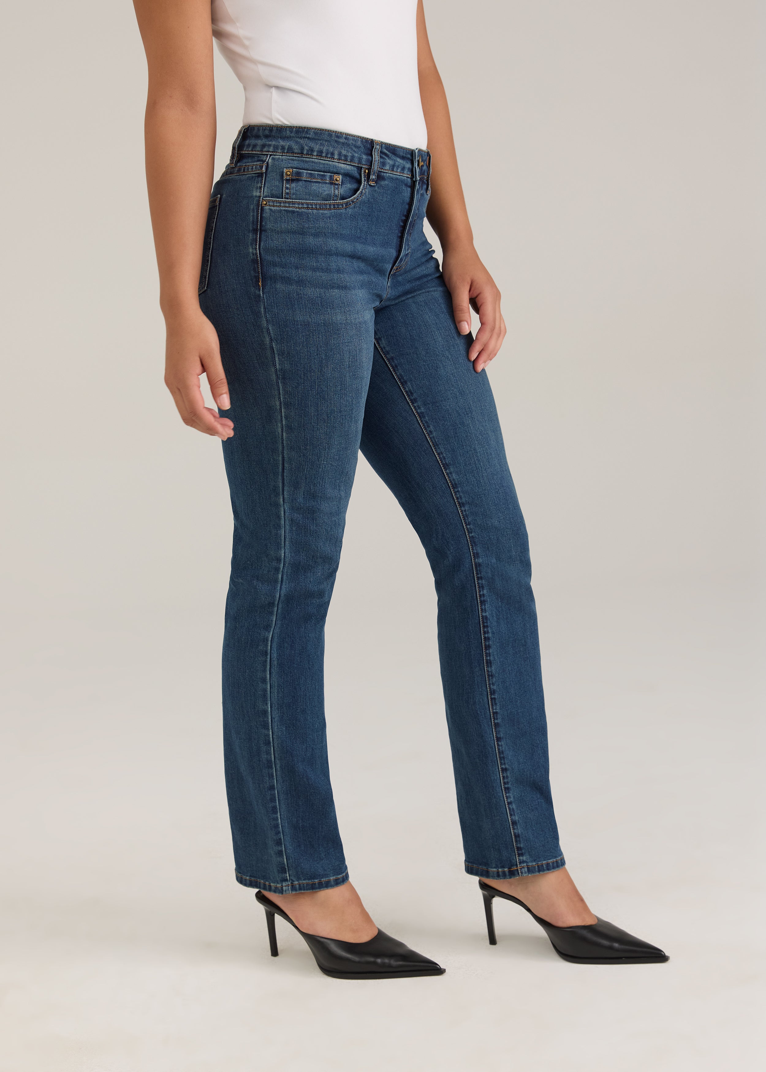 Side profile of Olivia straight leg denim in dark wash highlighting slim fit and mid-rise waist by French Dressing Jeans (FDJ)