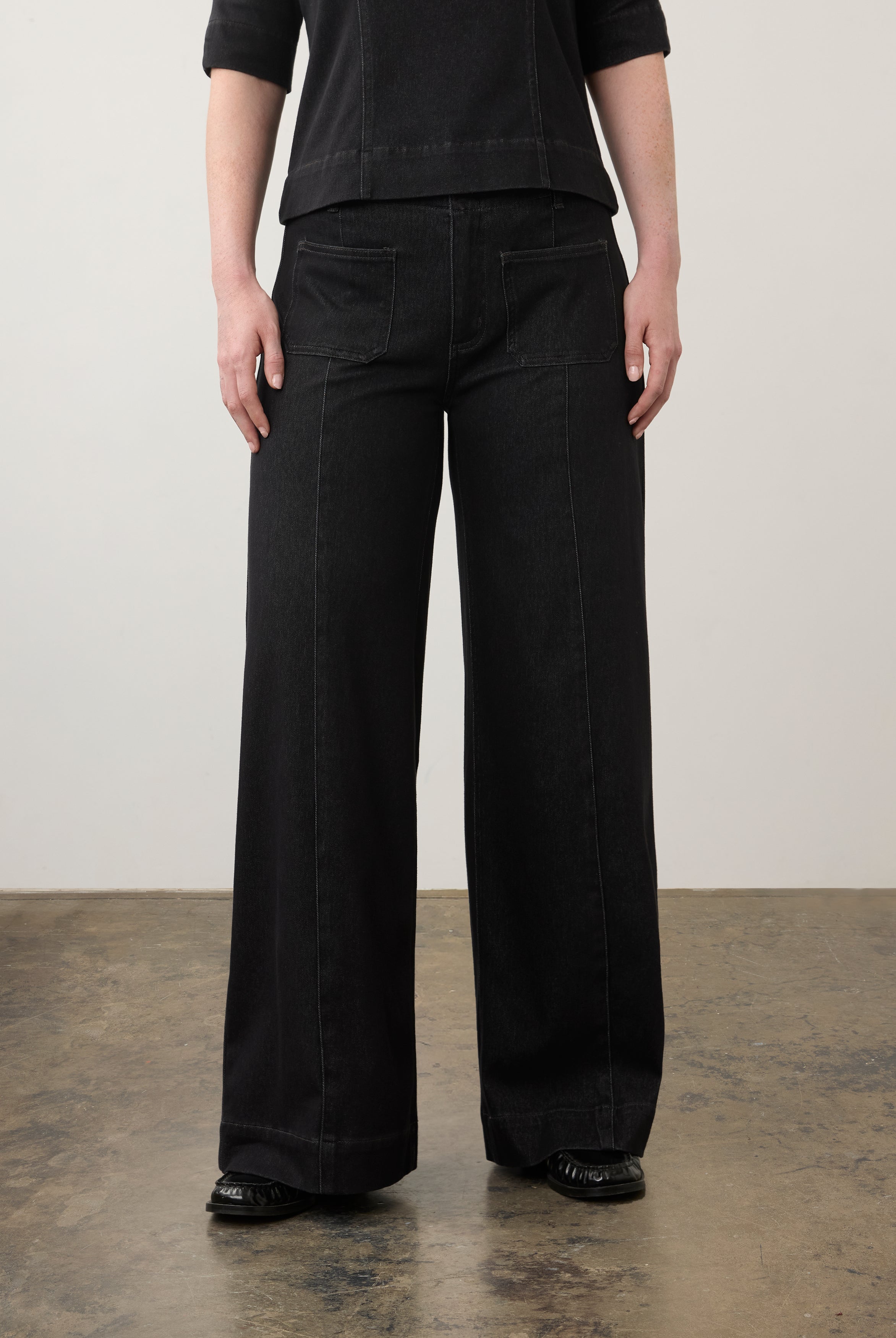 Close-up of black wide-leg jeans highlighting front pockets and waistband by French Dressing Jeans (FDJ)