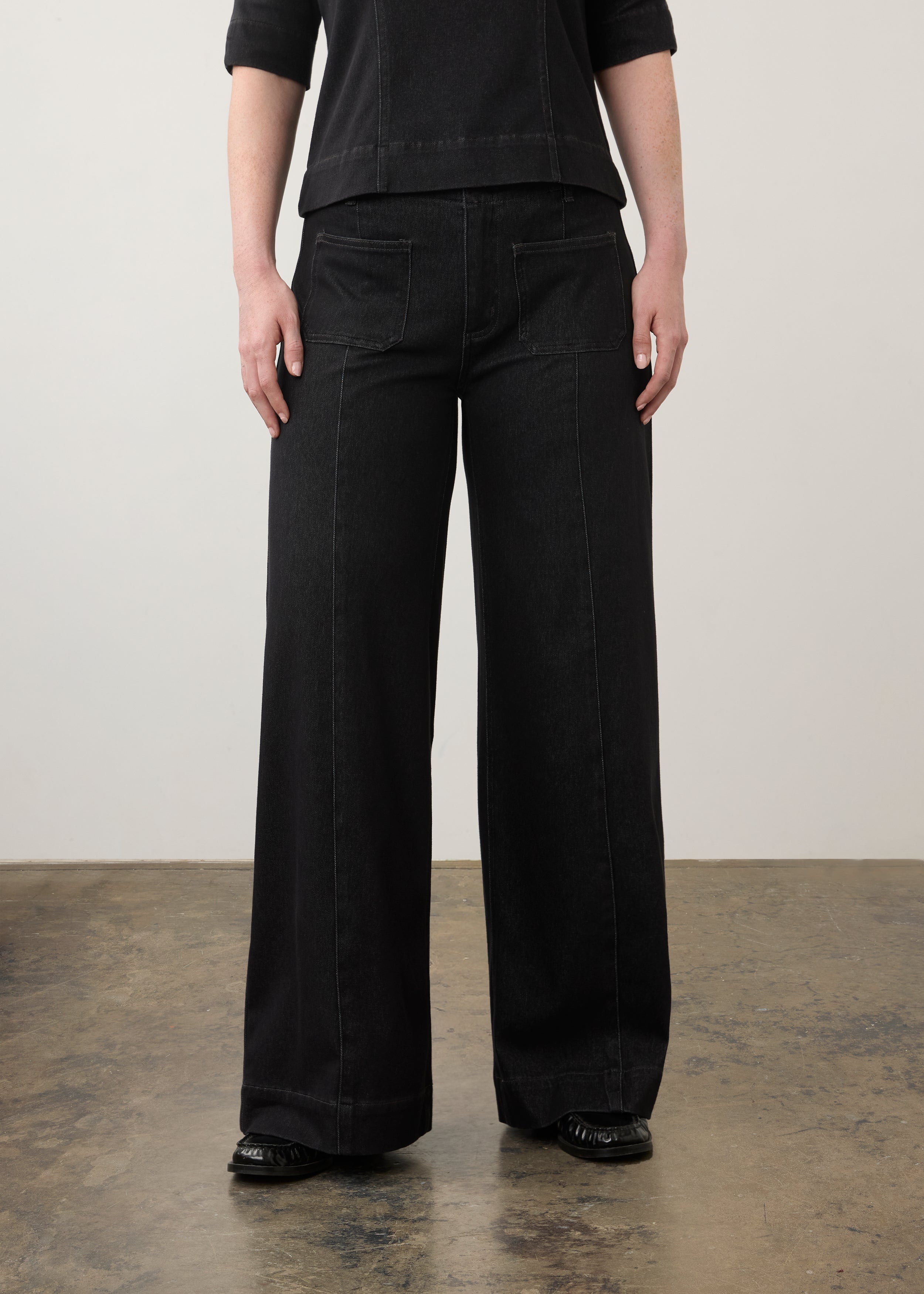 Close-up of black wide-leg jeans highlighting front pockets and waistband by French Dressing Jeans (FDJ)