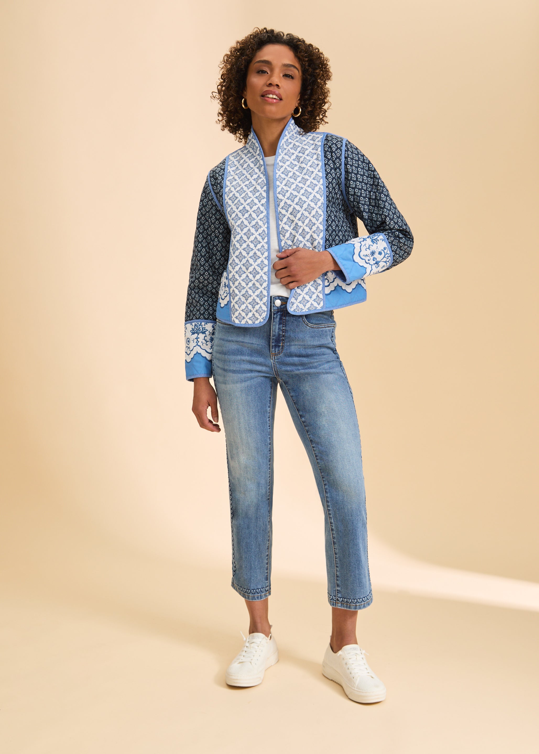 Full body view of patterned quilted jacket styled with jeans and sneakers by French Dressing Jeans (FDJ)