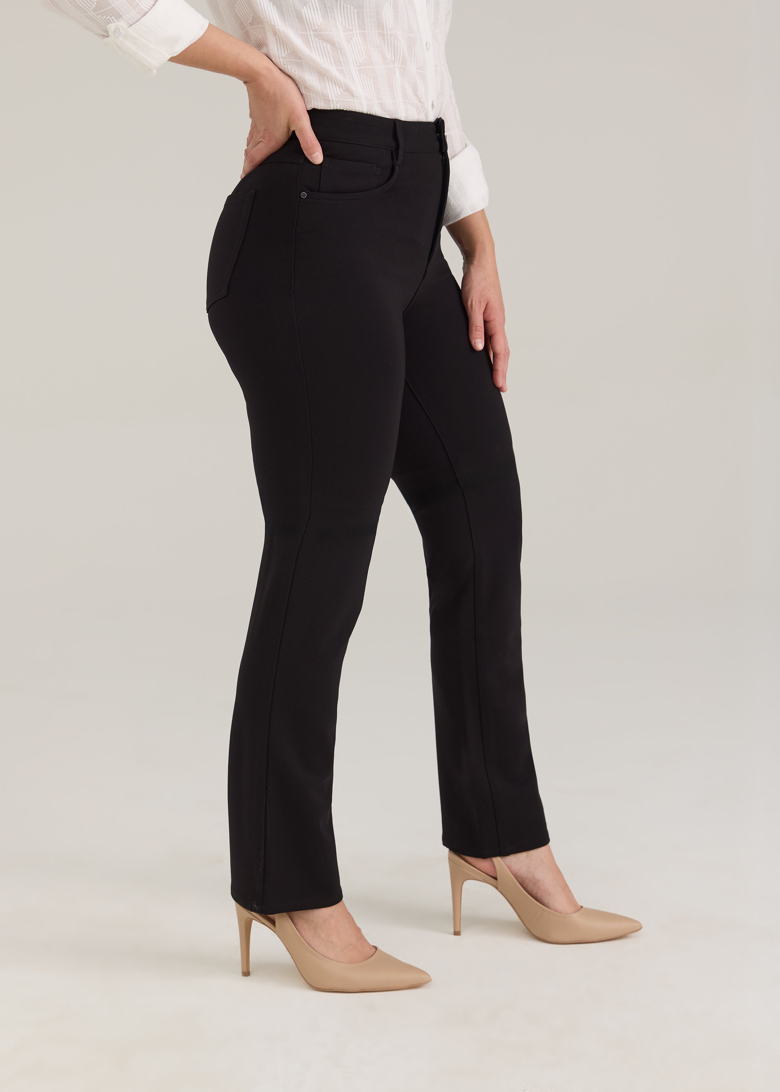 Side view of black pants showing leg silhouette and front pockets by French Dressing Jeans (FDJ)
