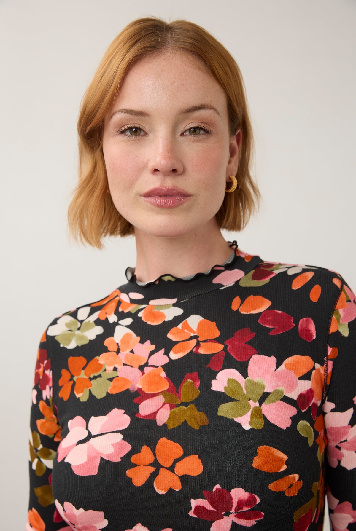 Close-up of vibrant floral top, showcasing detailed pattern and ruffled neckline by French Dressing Jeans (FDJ)