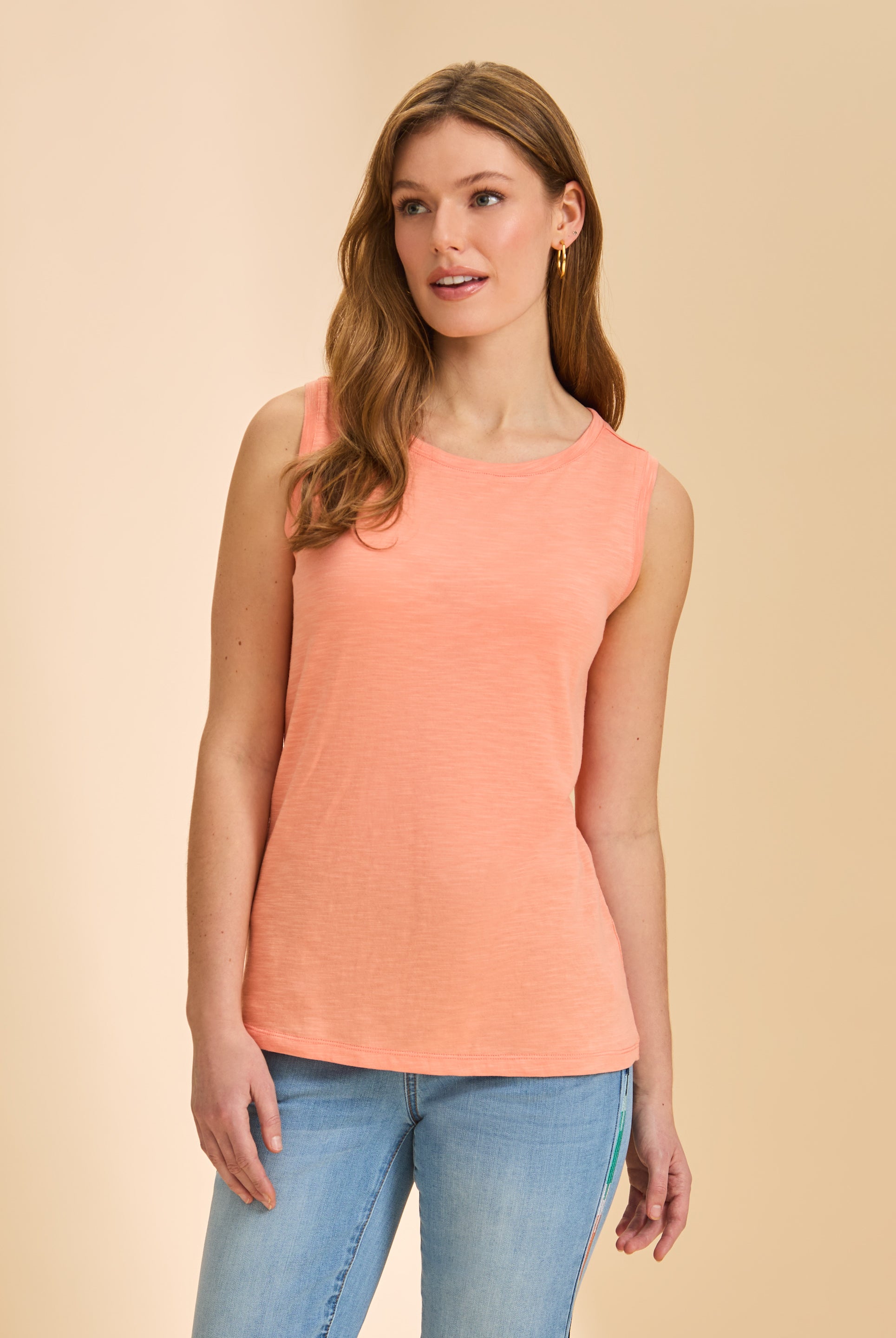Front view of coral sleeveless top with round neckline paired with light denim by French Dressing Jeans (FDJ)