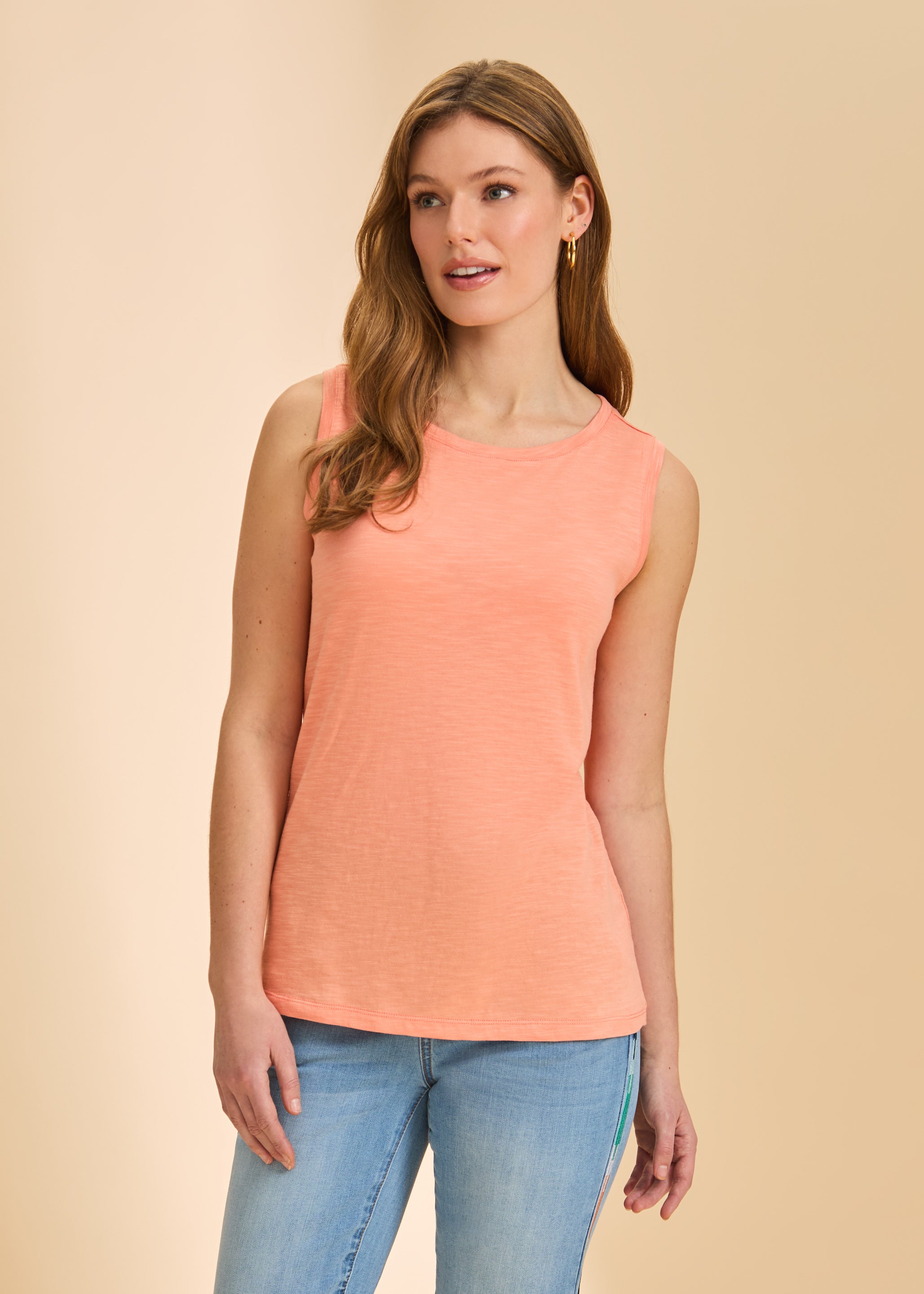 Front view of coral sleeveless top with round neckline paired with light denim by French Dressing Jeans (FDJ)