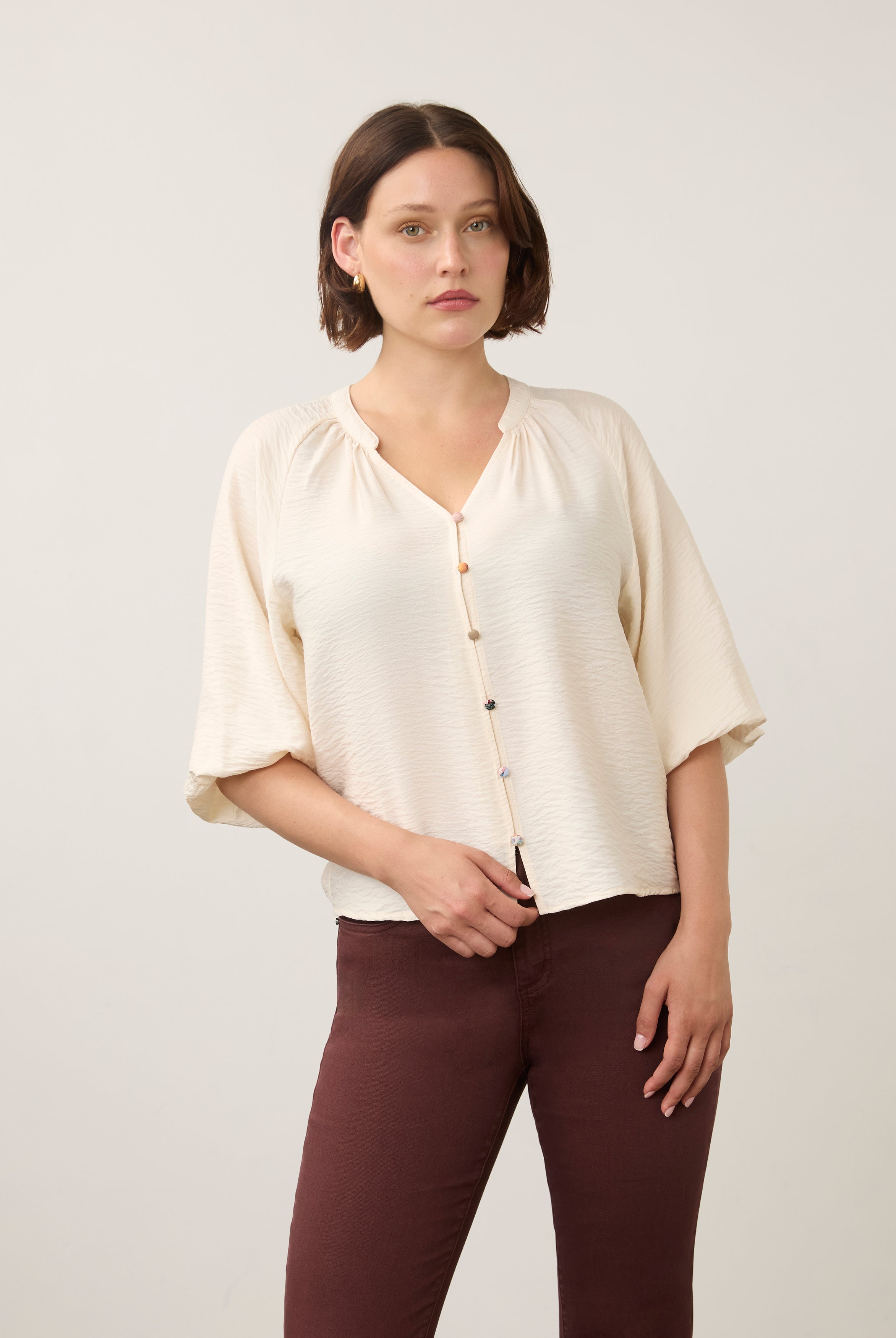 Front view of cream blouse with colorful buttons and V-neck by French Dressing Jeans (FDJ)