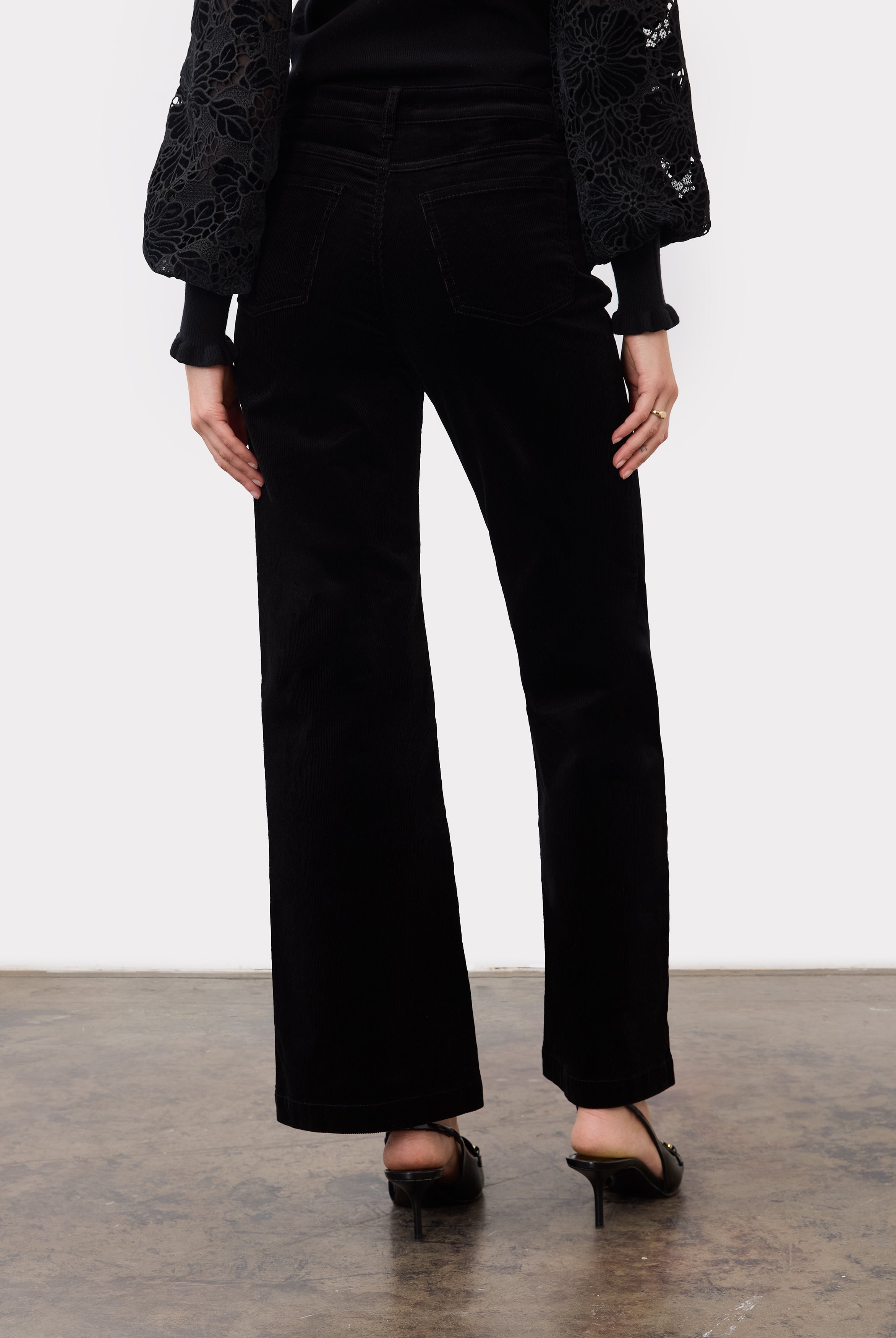 Back view of black wide leg pants highlighting back patch pockets and relaxed fit by French Dressing Jeans (FDJ)