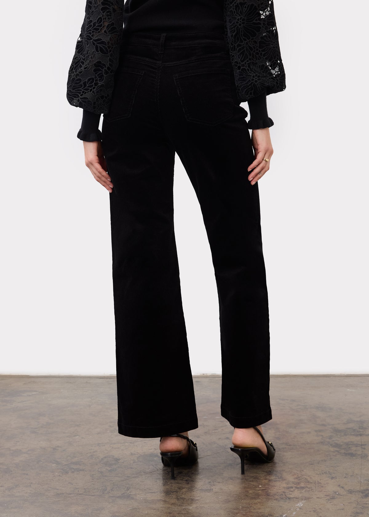 Back view of black wide leg pants highlighting back patch pockets and relaxed fit by French Dressing Jeans (FDJ)