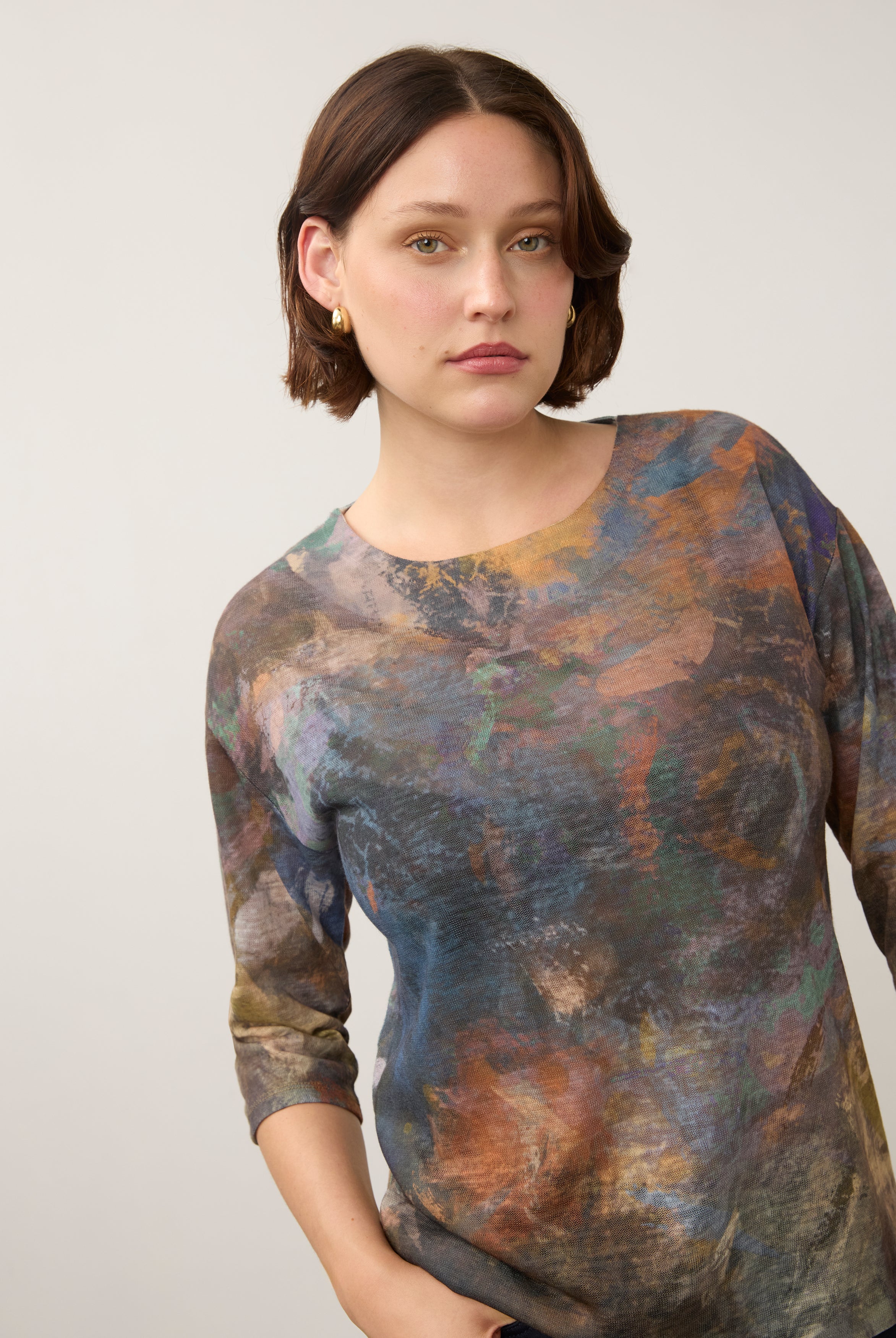 Close-up of earthy-toned Henley top emphasizing round neckline and pattern by French Dressing Jeans (FDJ)
