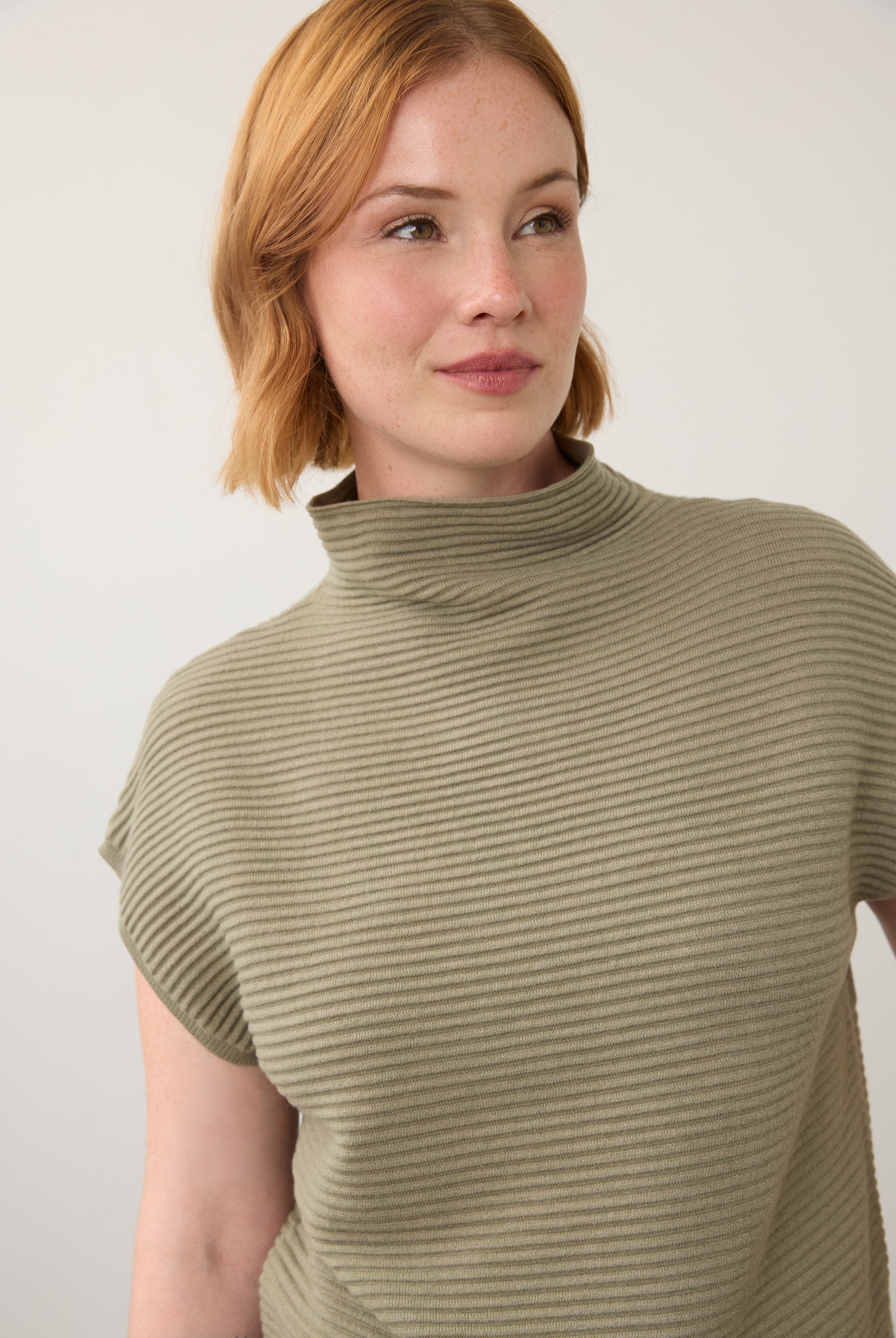 Close-up of olive green ribbed top showing high collar and short sleeves by French Dressing Jeans (FDJ)