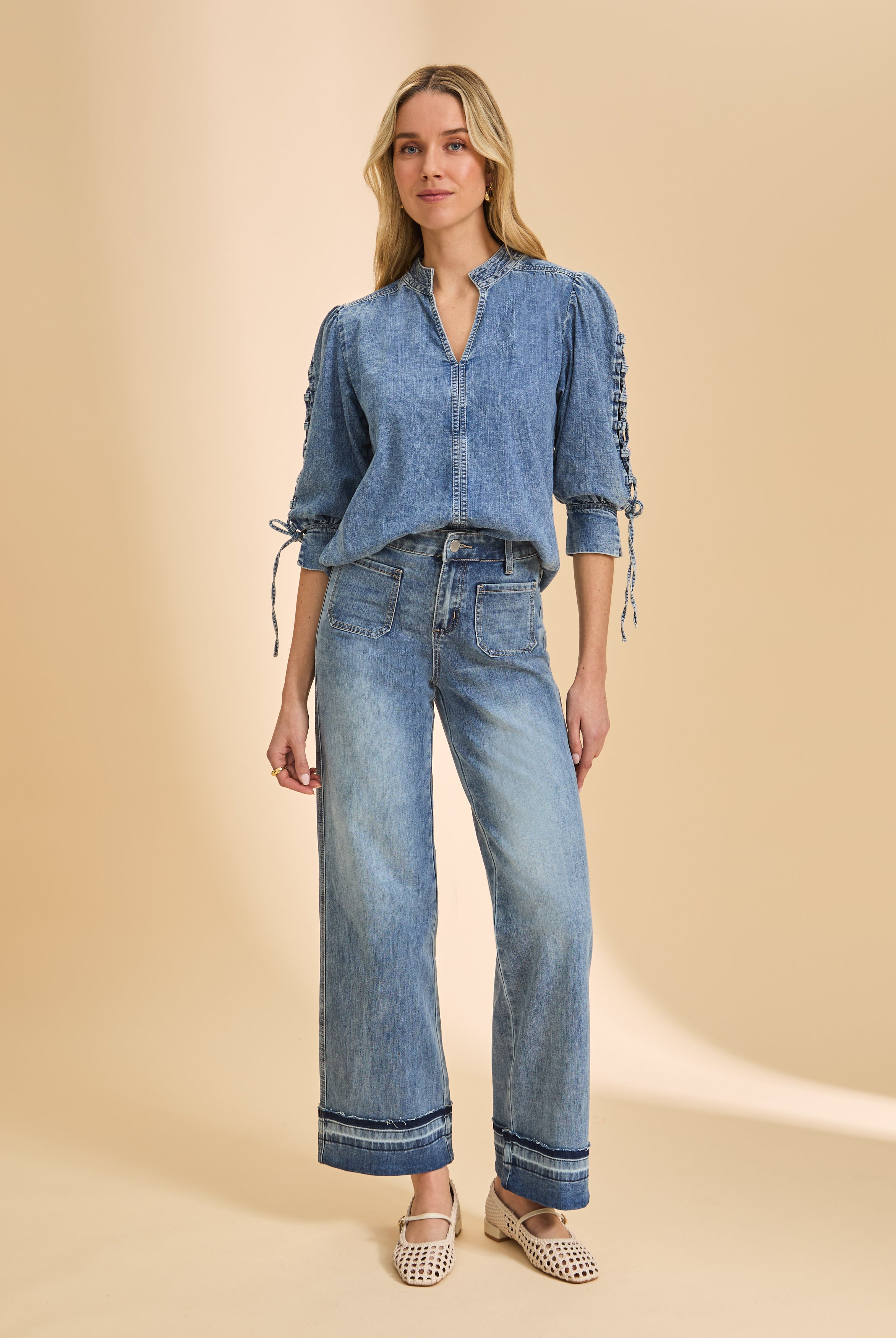 Model in wide-leg denim with cuffed hem and patch pockets by French Dressing Jeans (FDJ)