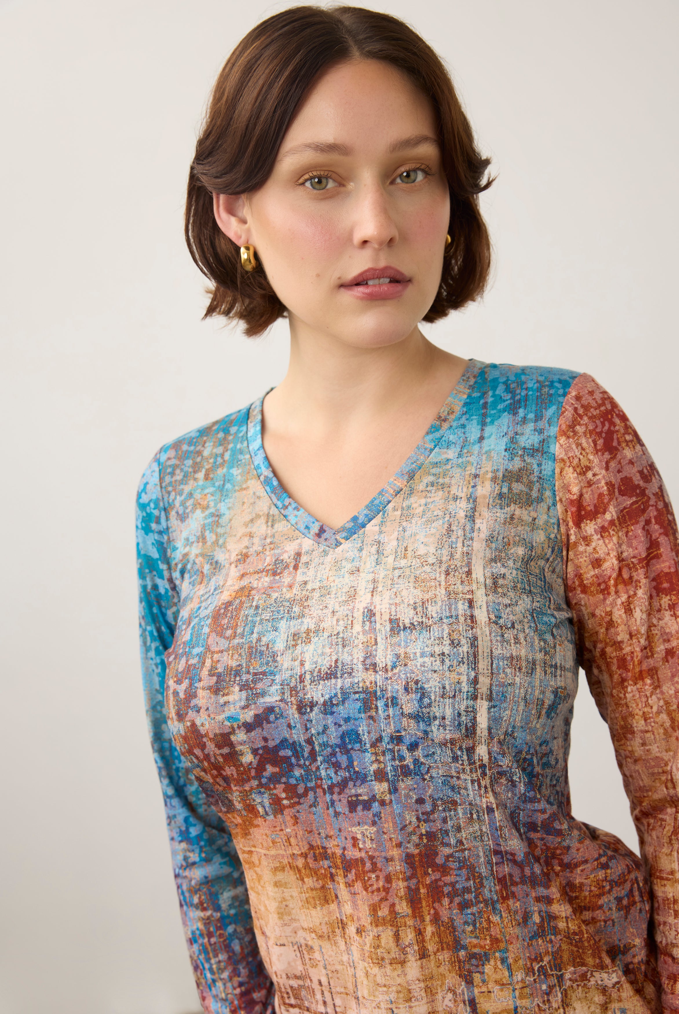 Close-up of V-neck and pattern detail on colorful gradient long sleeve top by French Dressing Jeans (FDJ)