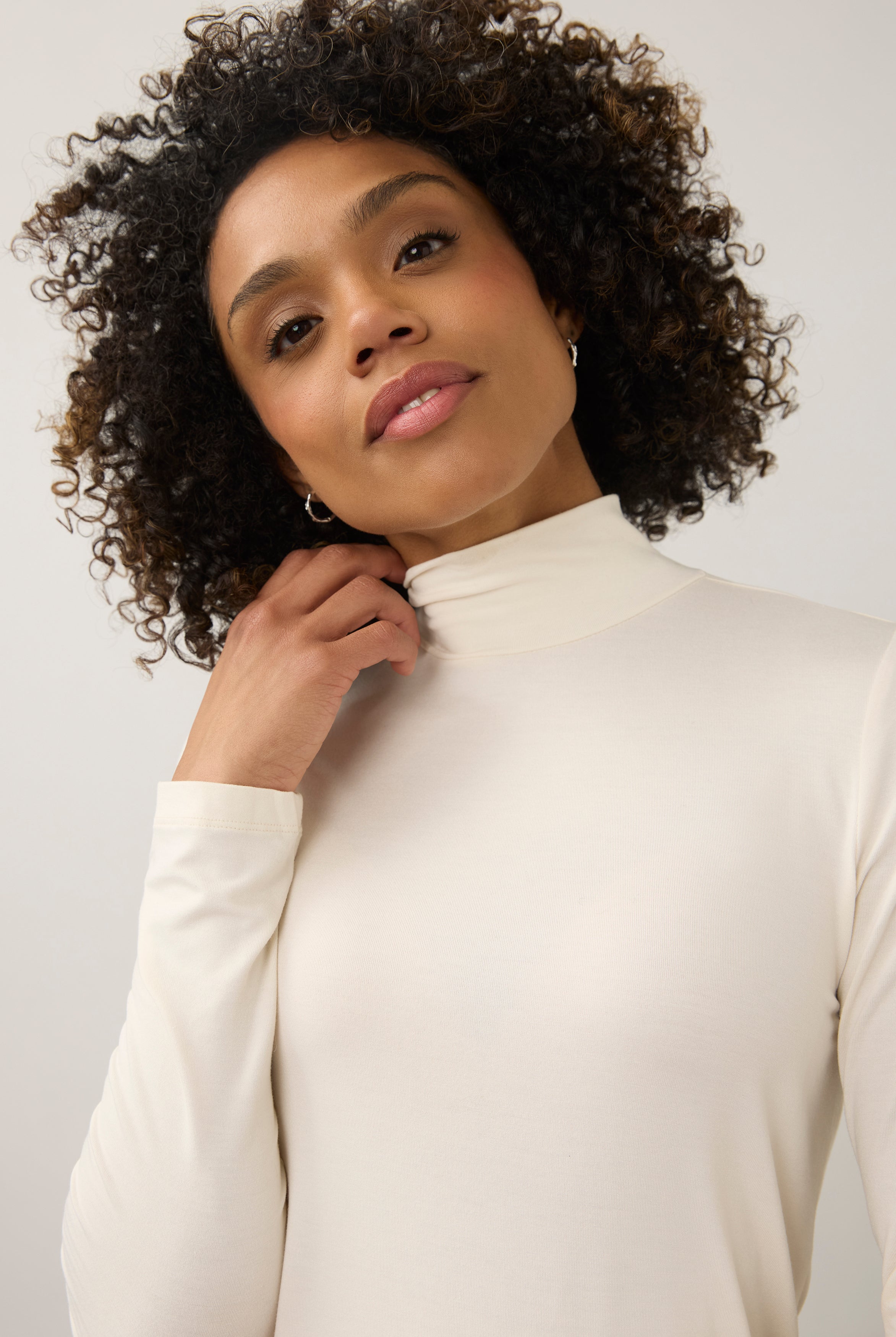 Close-up of cream turtleneck top focusing on neckline and soft stretch fabric by French Dressing Jeans (FDJ)