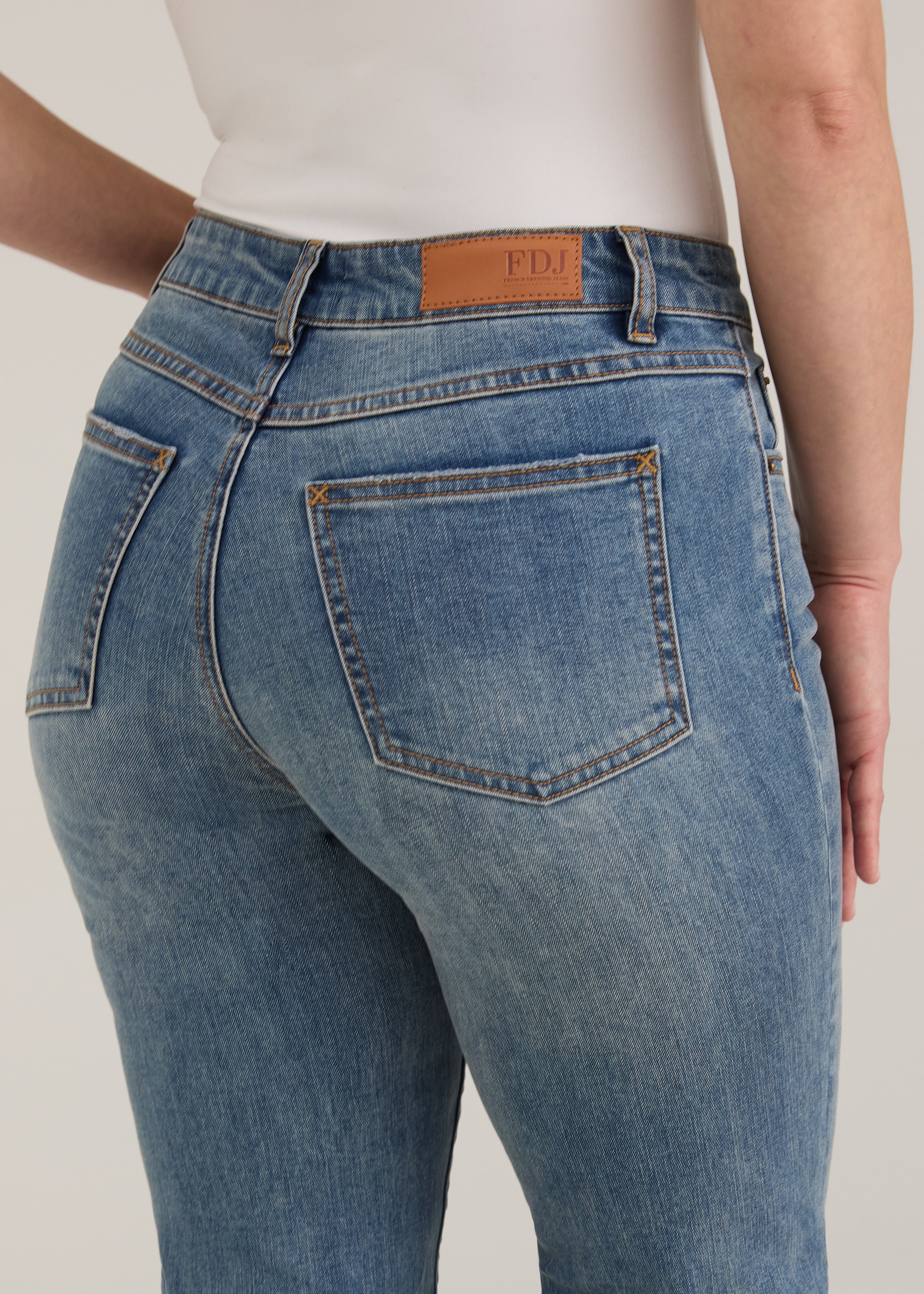 Detail shot of back pockets and waistline on light wash Olivia straight leg denim by French Dressing Jeans (FDJ)