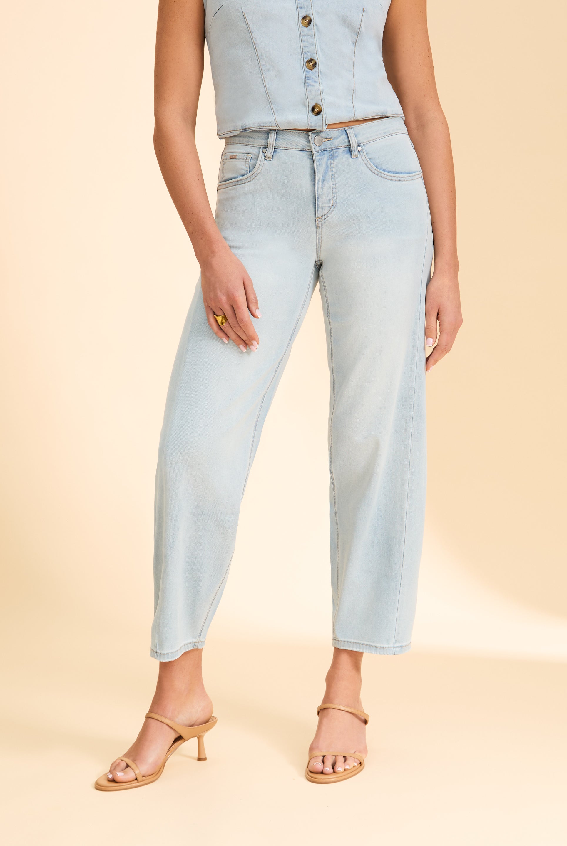 Close-up of light wash denim jeans showing waistline and pocket details by French Dressing Jeans (FDJ)