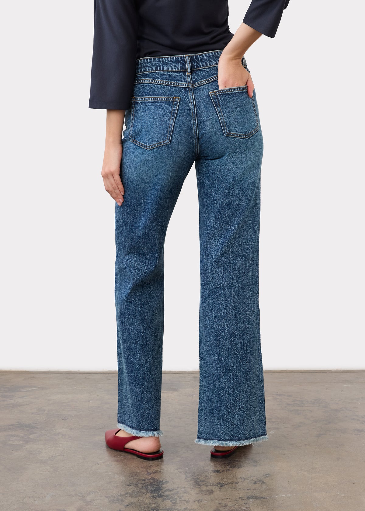 Back view showing patch pockets and bootleg cut in medium blue denim by French Dressing Jeans (FDJ)