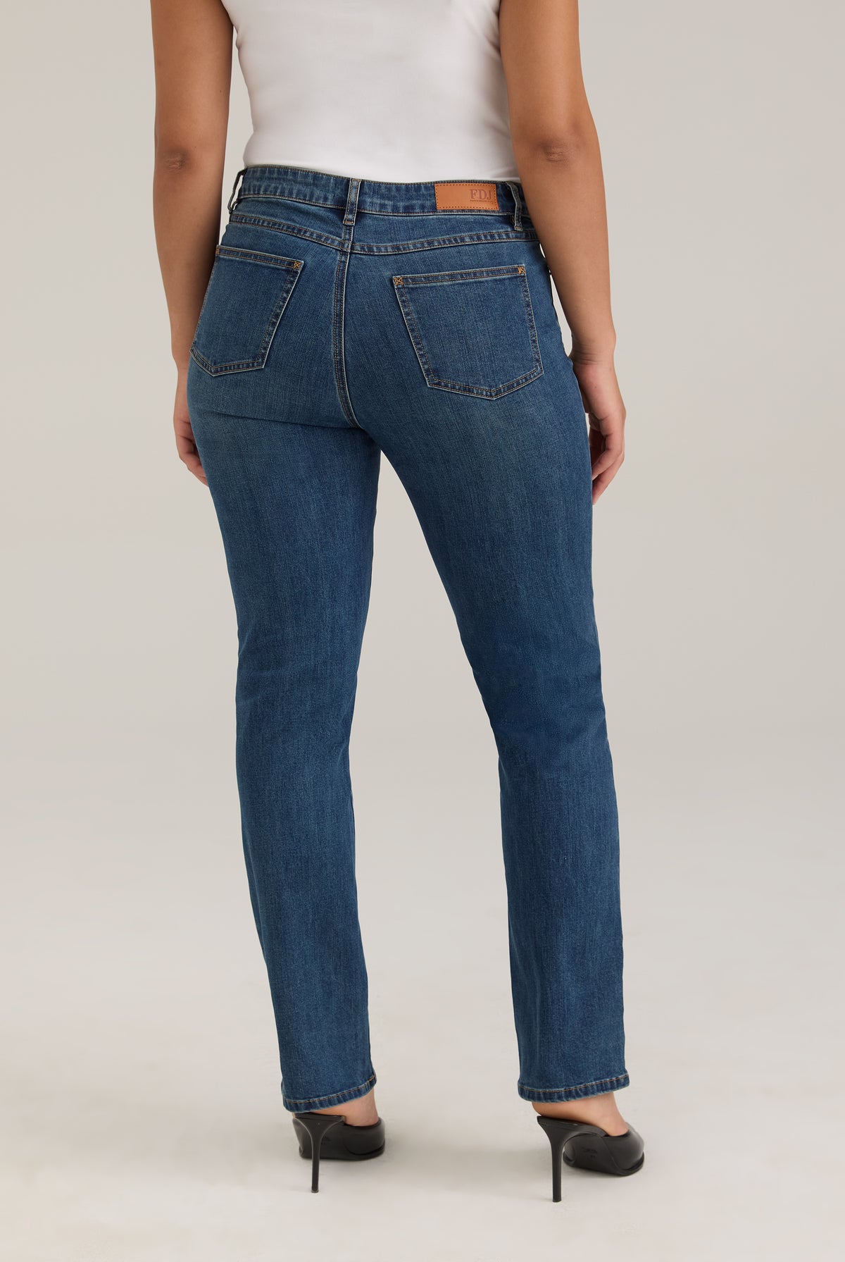 Back view of Olivia straight leg jeans in dark wash featuring back pockets and mid-rise design by French Dressing Jeans (FDJ)
