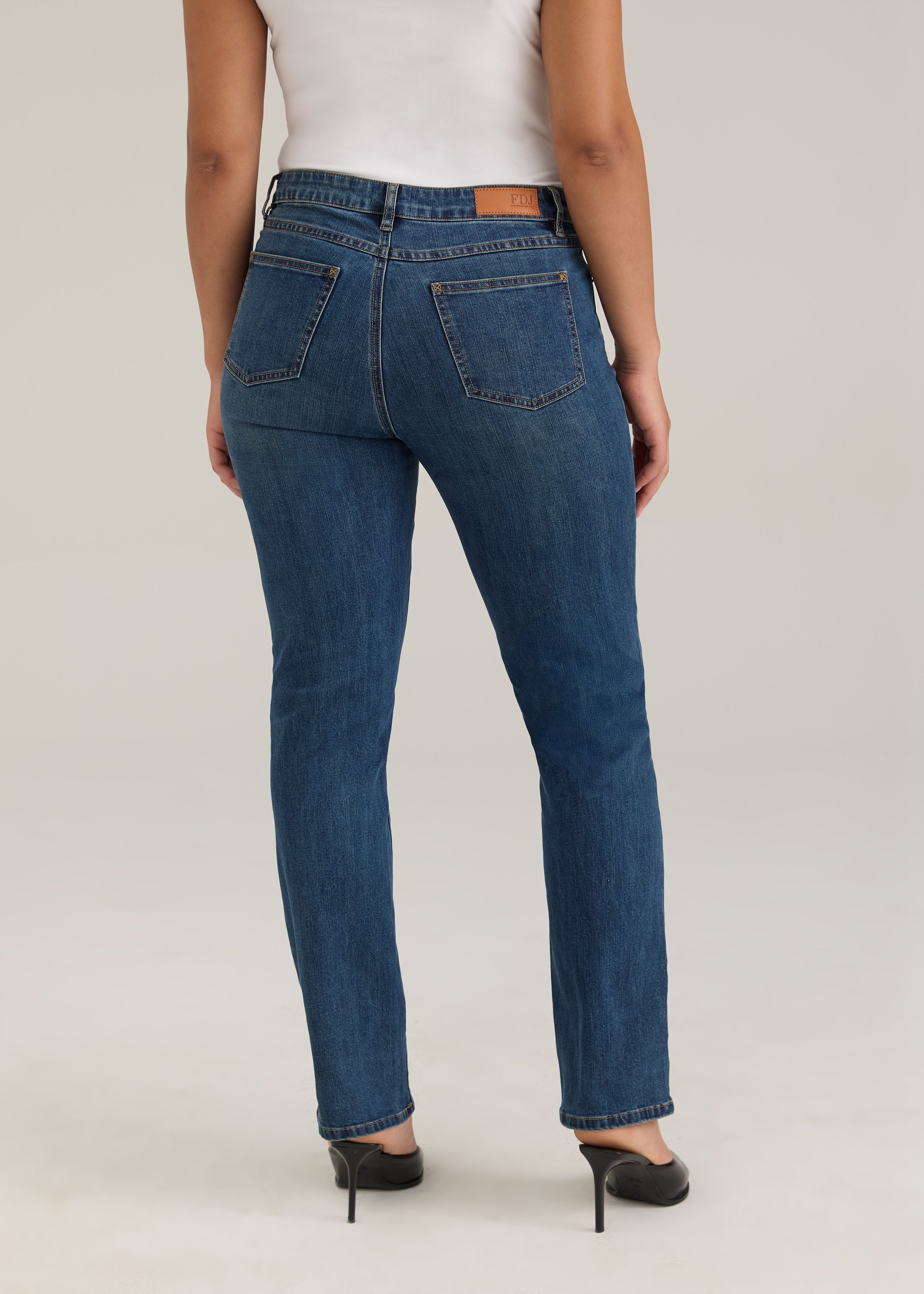 Back view of Olivia straight leg jeans in dark wash featuring back pockets and mid-rise design by French Dressing Jeans (FDJ)