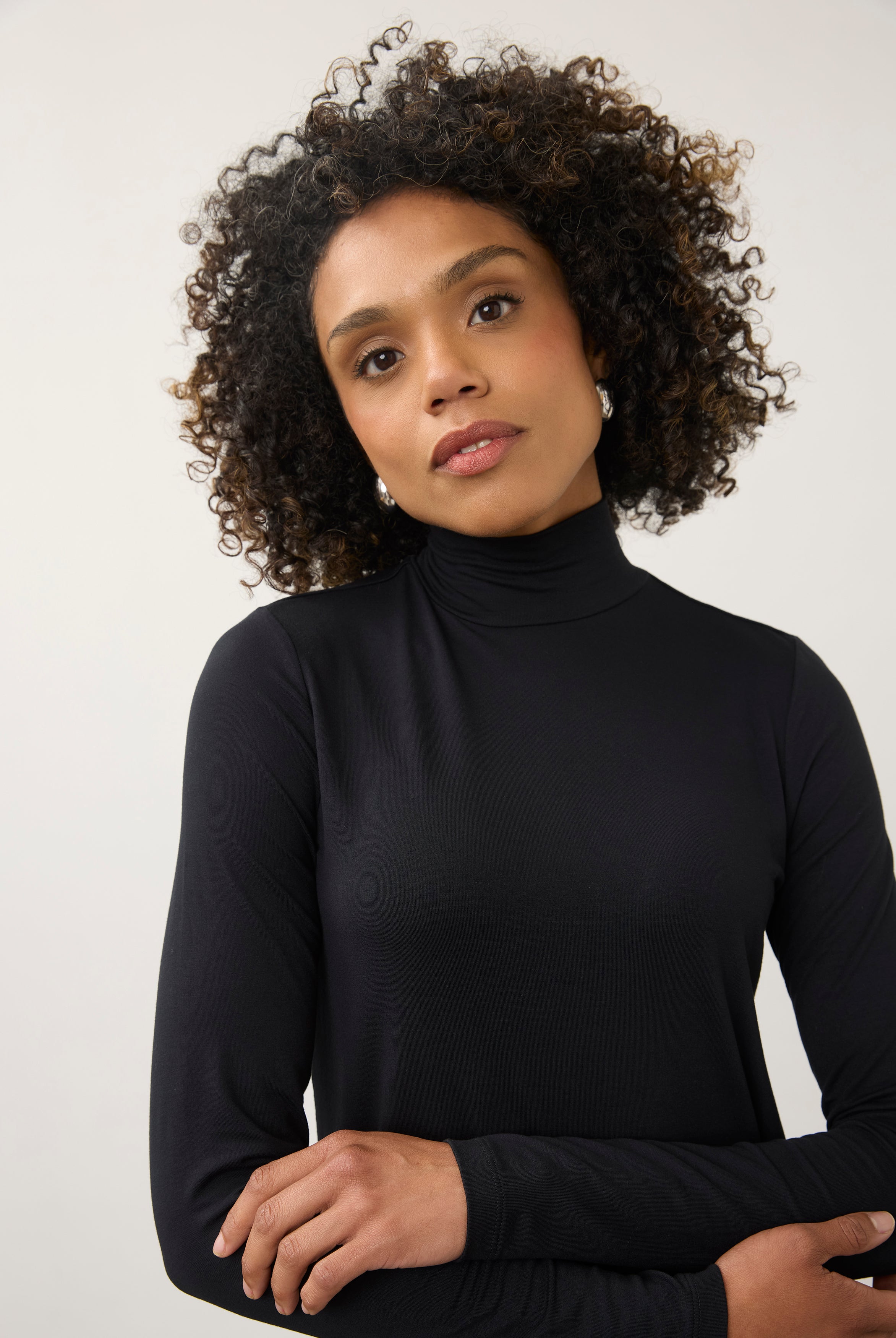 Close-up of black turtleneck top focusing on neckline and soft stretch fabric by French Dressing Jeans (FDJ)