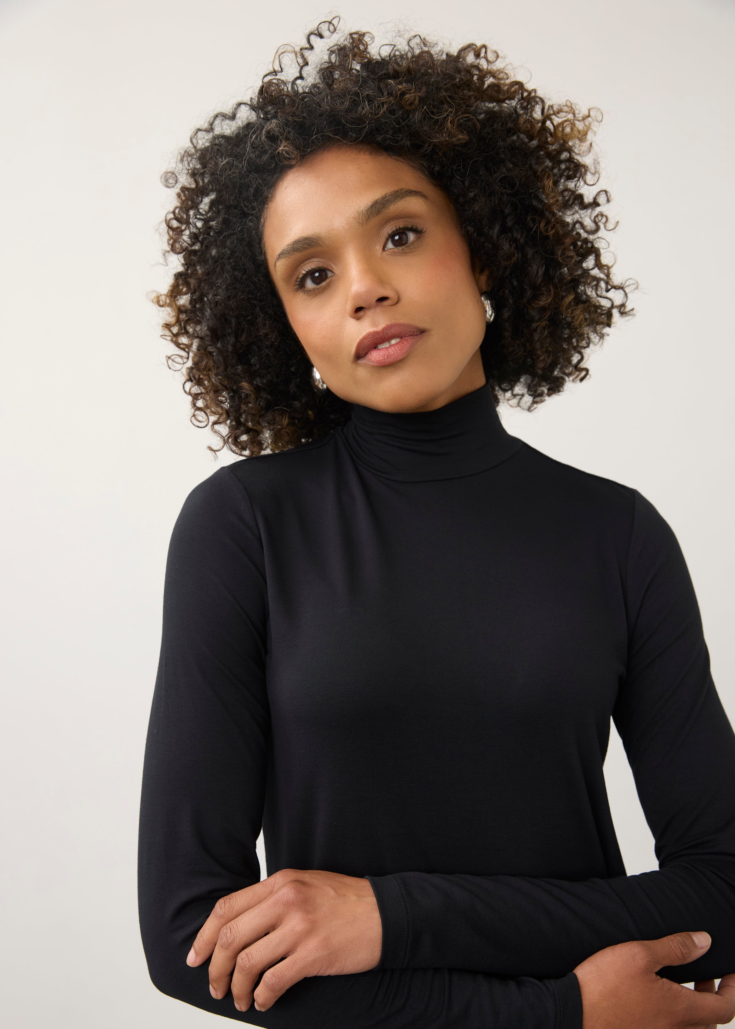 Close-up of black turtleneck top focusing on neckline and soft stretch fabric by French Dressing Jeans (FDJ)