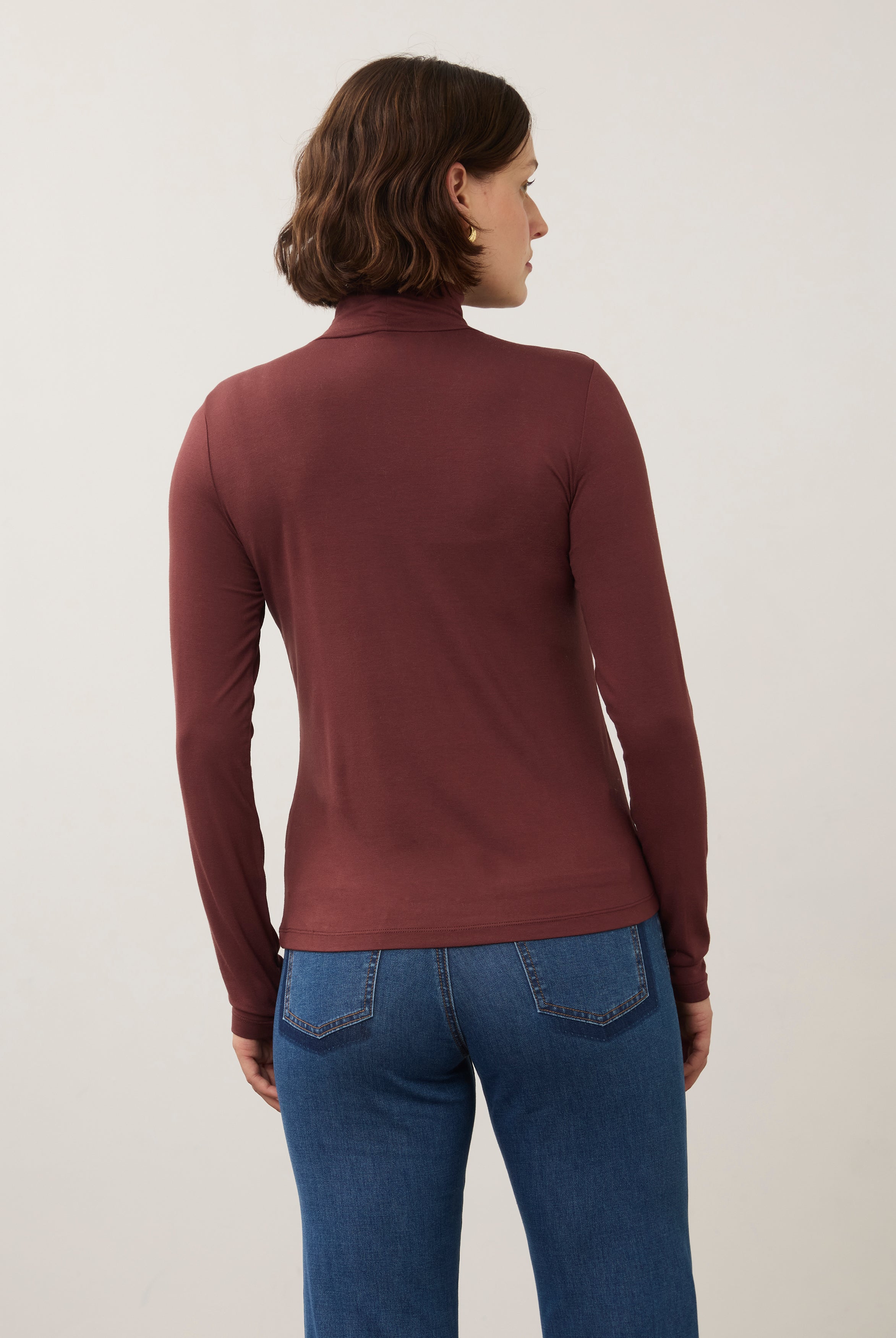 Back view of burgundy turtleneck top showcasing simple elegance and seamless design by French Dressing Jeans (FDJ)