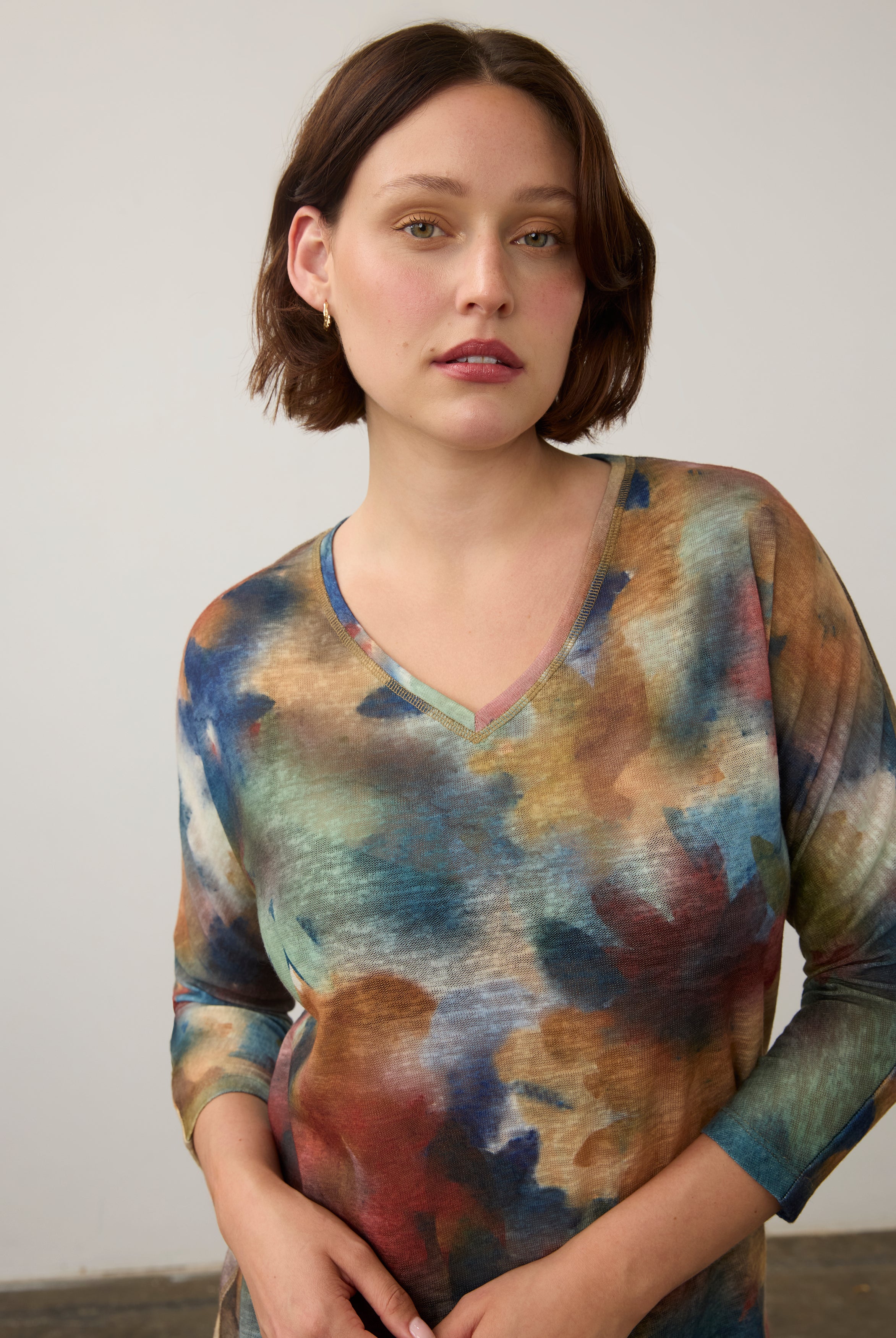 Close-up of watercolor Henley top highlighting V-neck and colorful design by French Dressing Jeans (FDJ)
