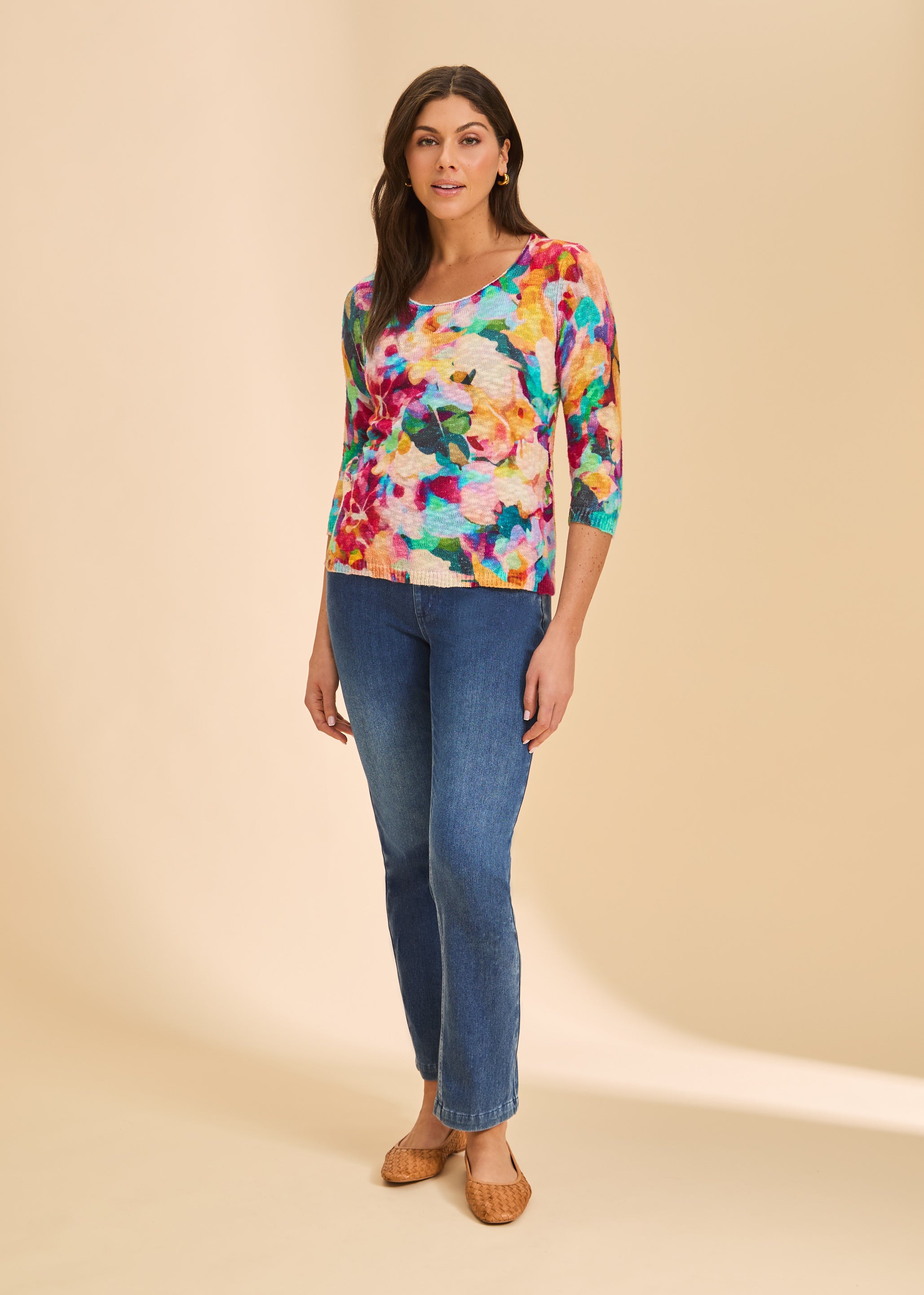 Full view of colorful floral sweater paired with blue jeans by French Dressing Jeans (FDJ)