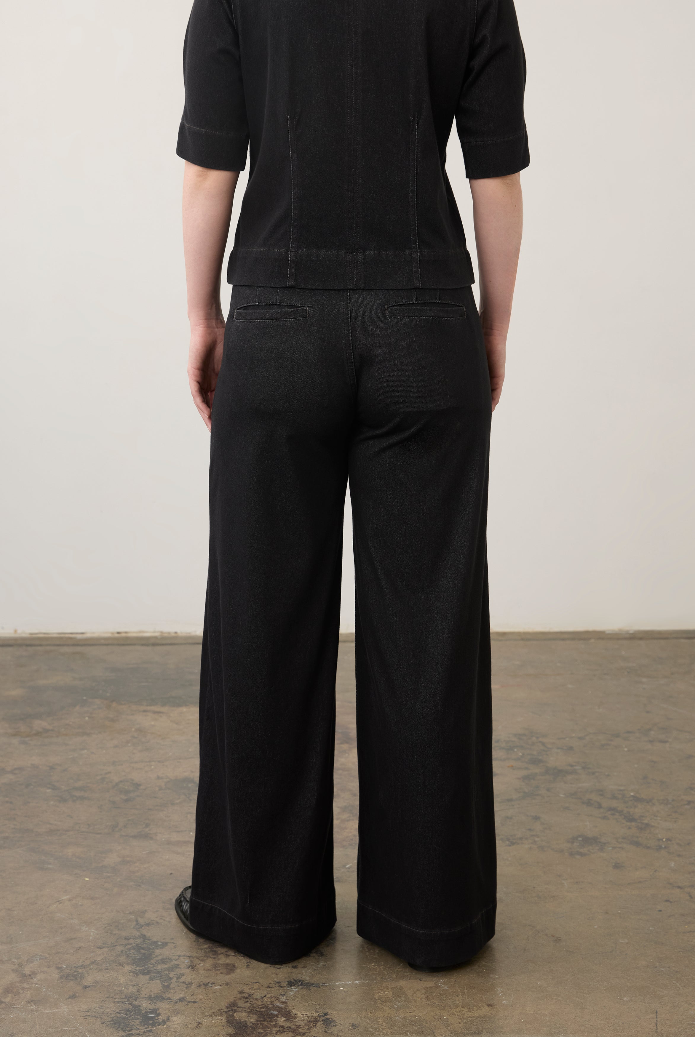 Back view of black wide-leg jeans showcasing welt pockets and seam lines by French Dressing Jeans (FDJ)