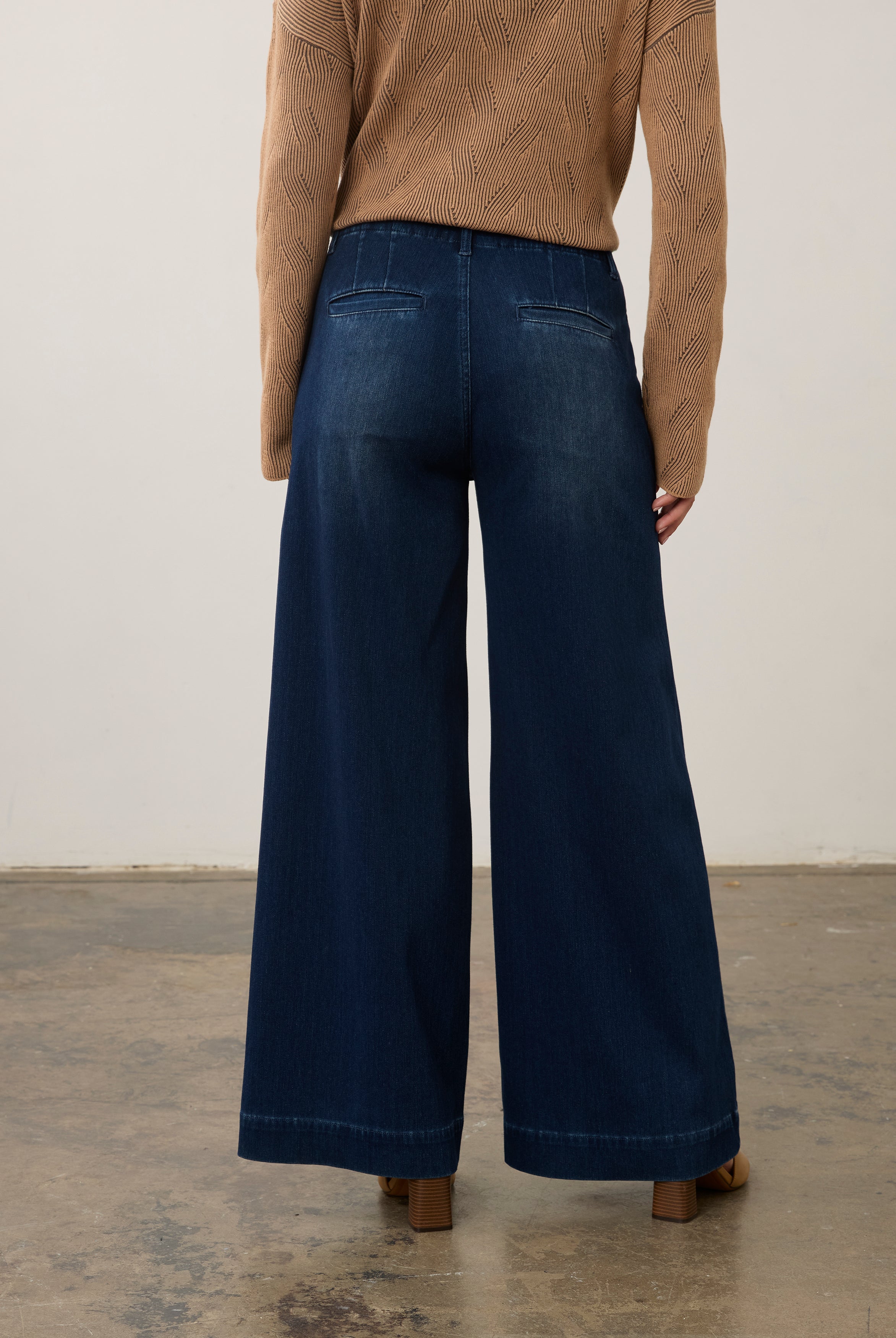 Back view of dark rinse wide-leg jeans highlighting rear pockets and faded finish by French Dressing Jeans (FDJ)