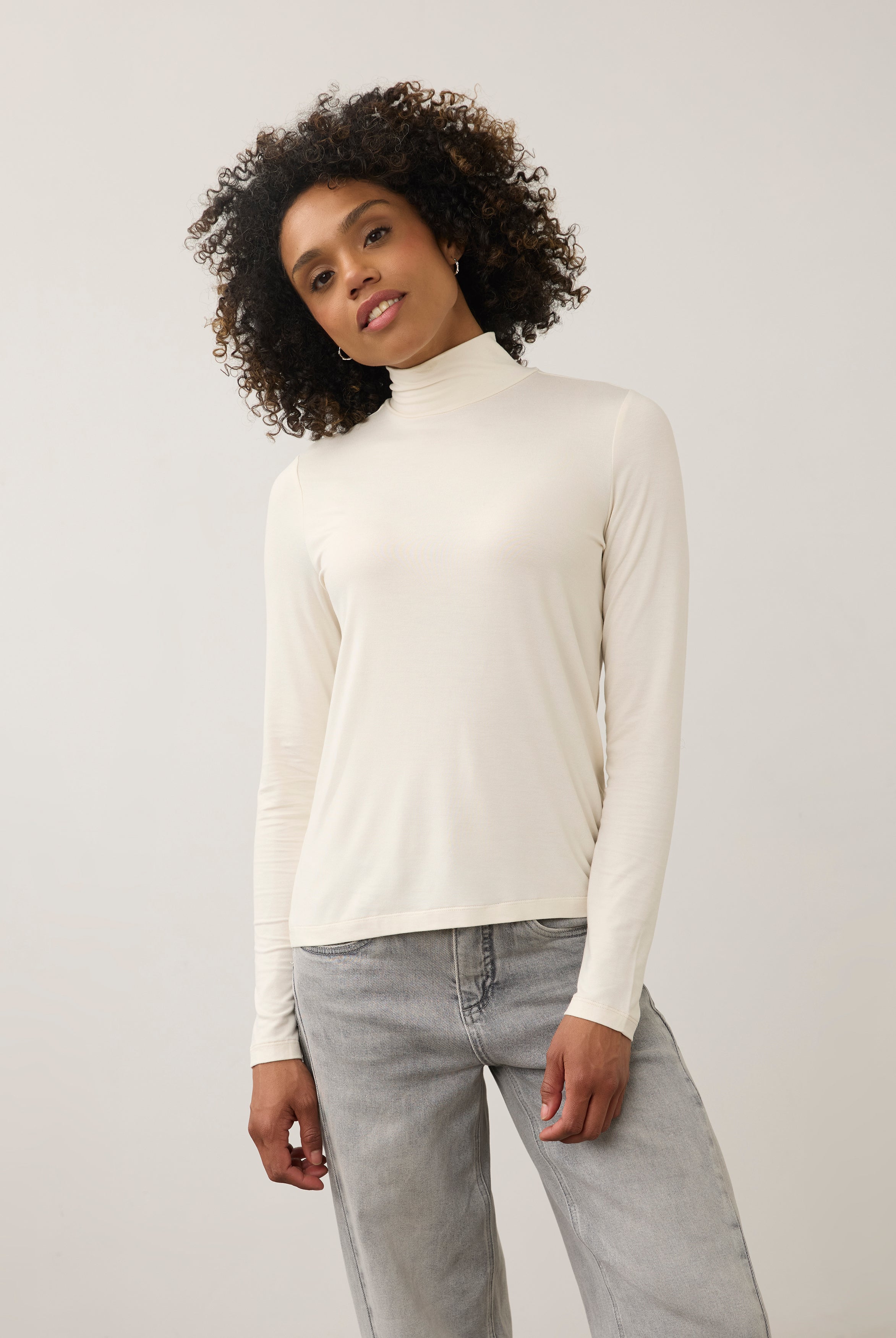 Front view of cream turtleneck top with long sleeves and soft stretch fabric by French Dressing Jeans (FDJ)