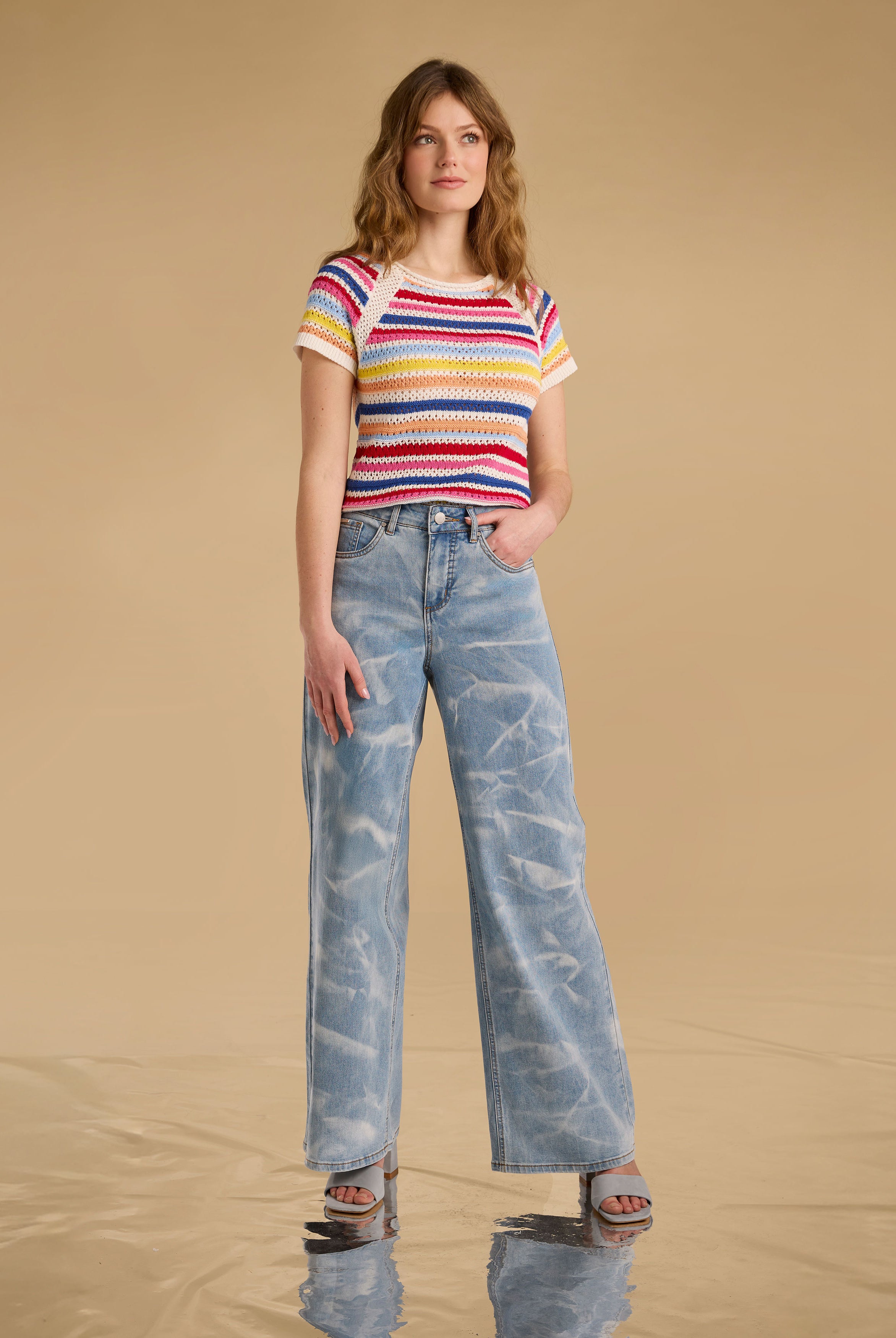 Model wearing multi-color stripe sweater with wide-leg jeans front view by French Dressing Jeans (FDJ)